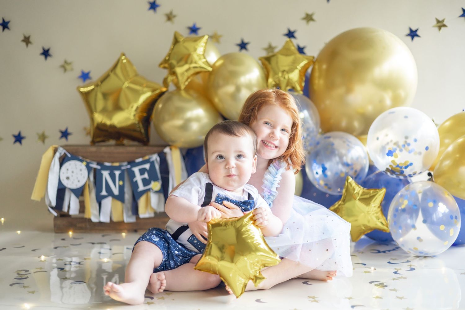 A series of connected photos showing party decorations with gold star balloons and blue stars against a white background.