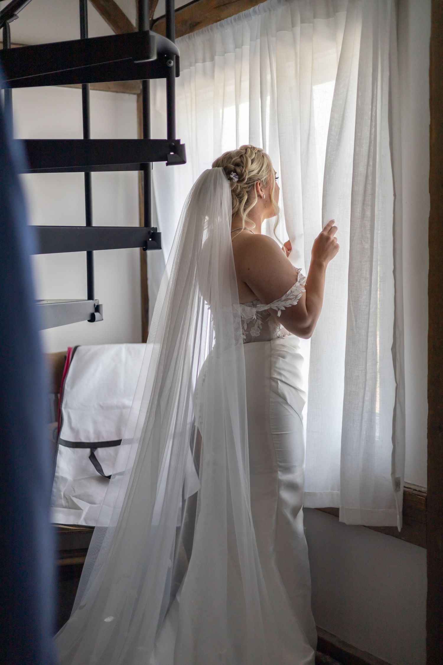 A sequence of images showing a person in a white dress moving behind sheer white curtains in a sunlit room.