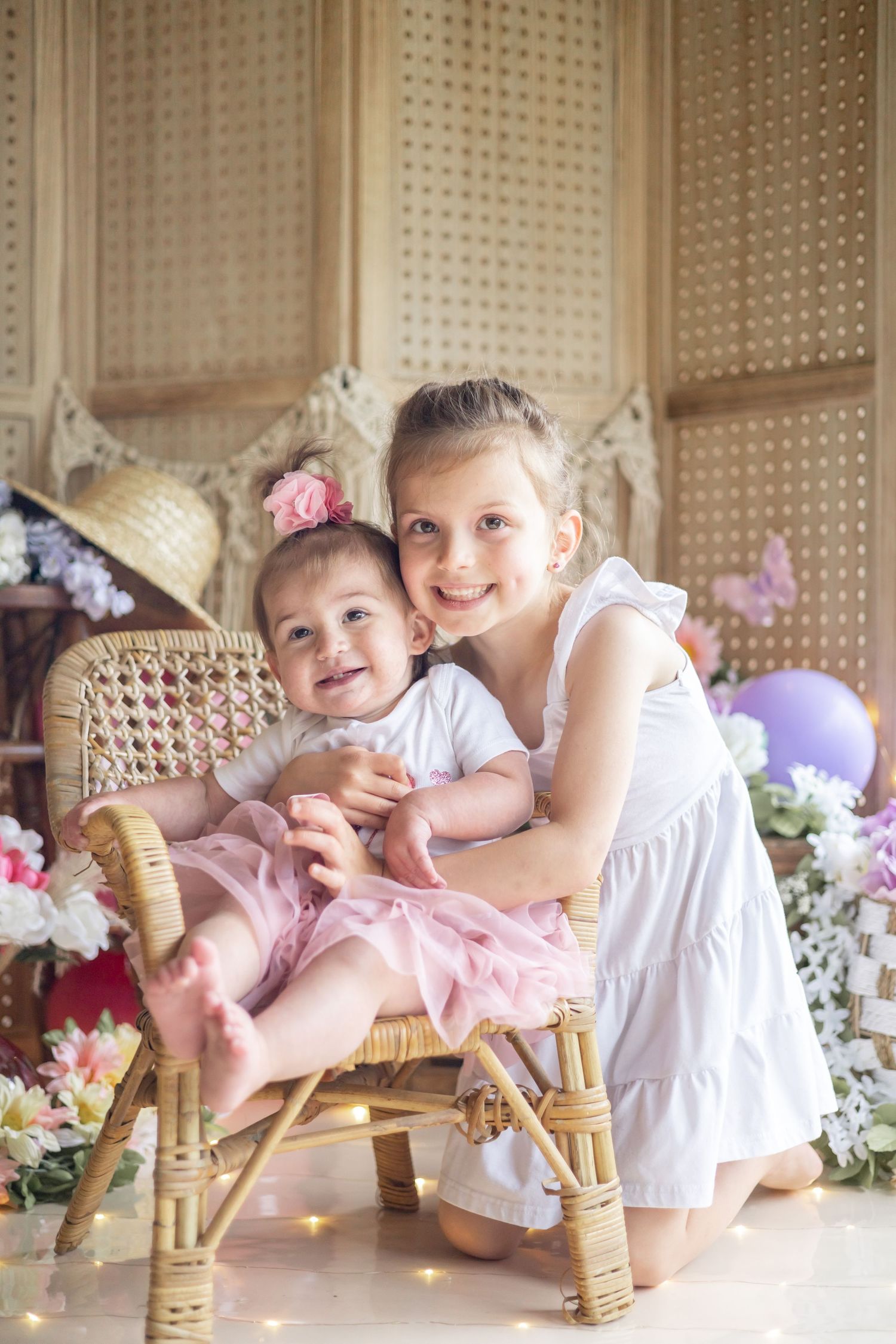 Collection of images showing children in white outfits resting on bamboo furniture with floral decorations and string lights.