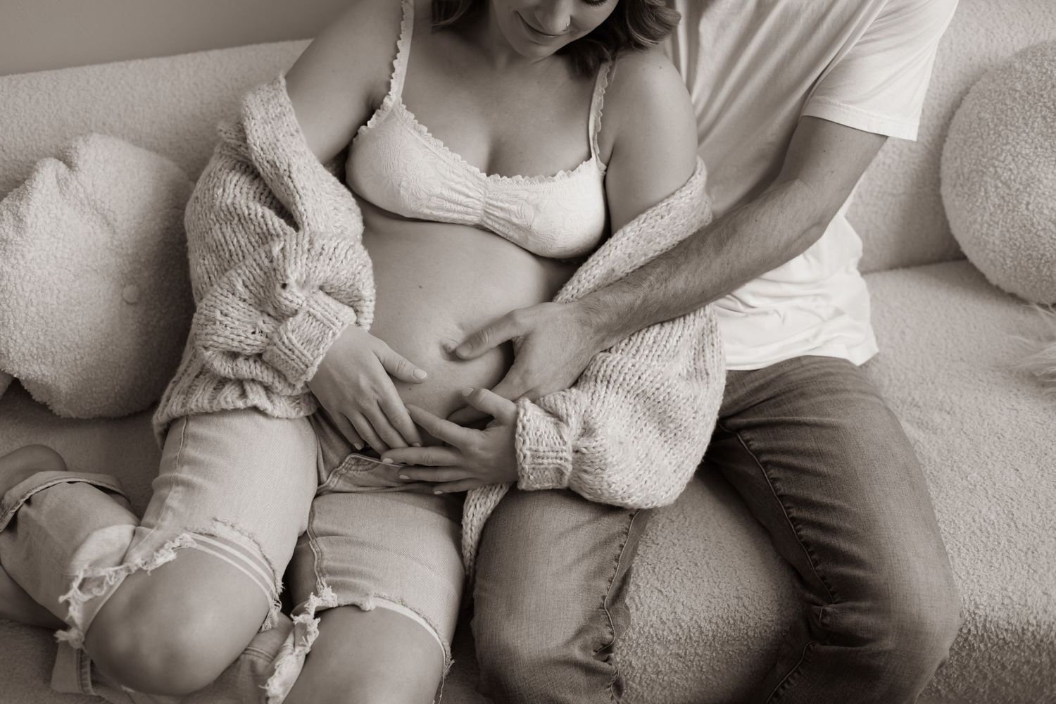 A series of intimate black and white maternity photographs showing pregnant bellies and tender embraces during pregnancy.
