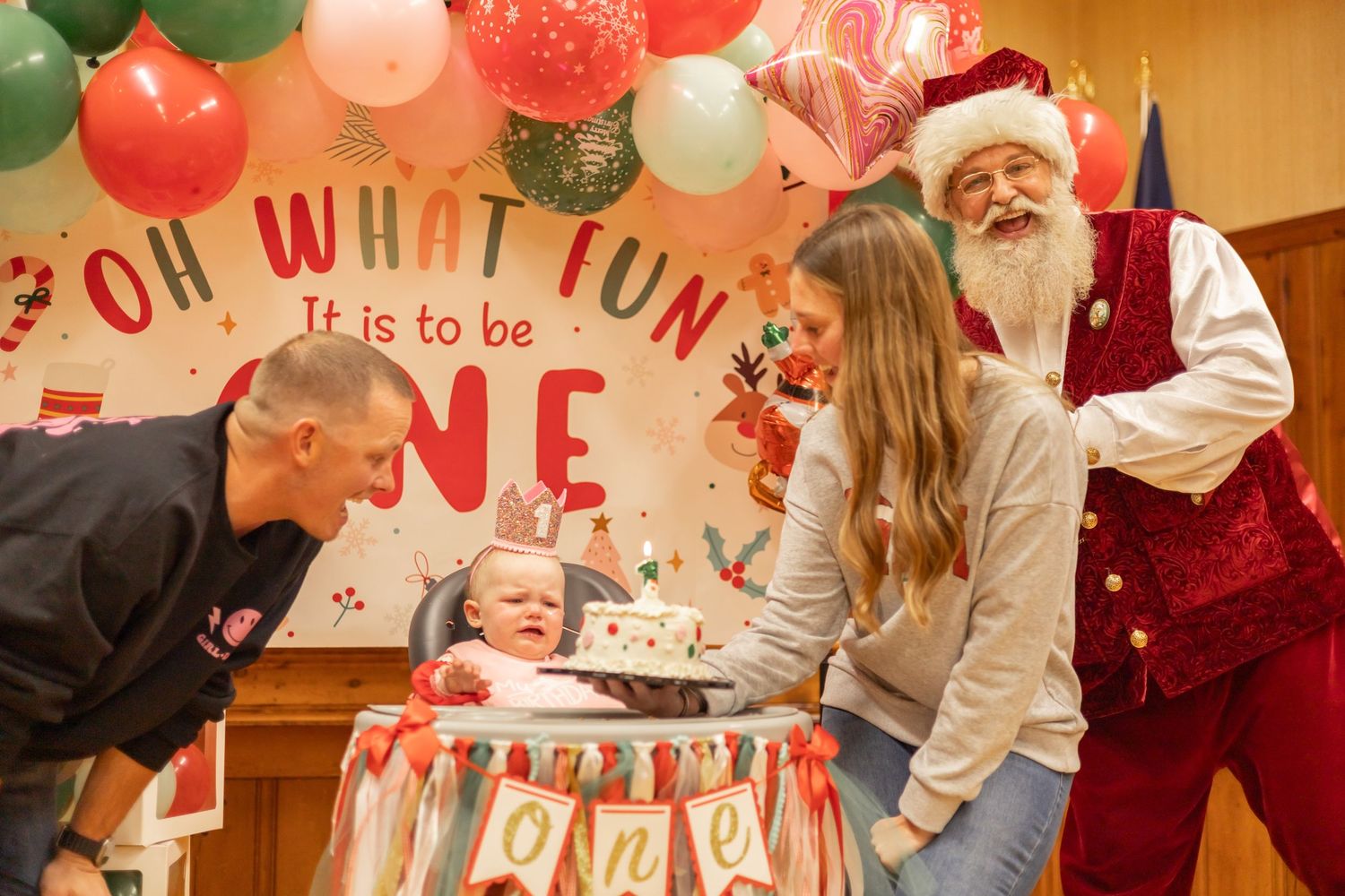 Holiday party decorations with red and green balloons create a festive atmosphere in a community space.