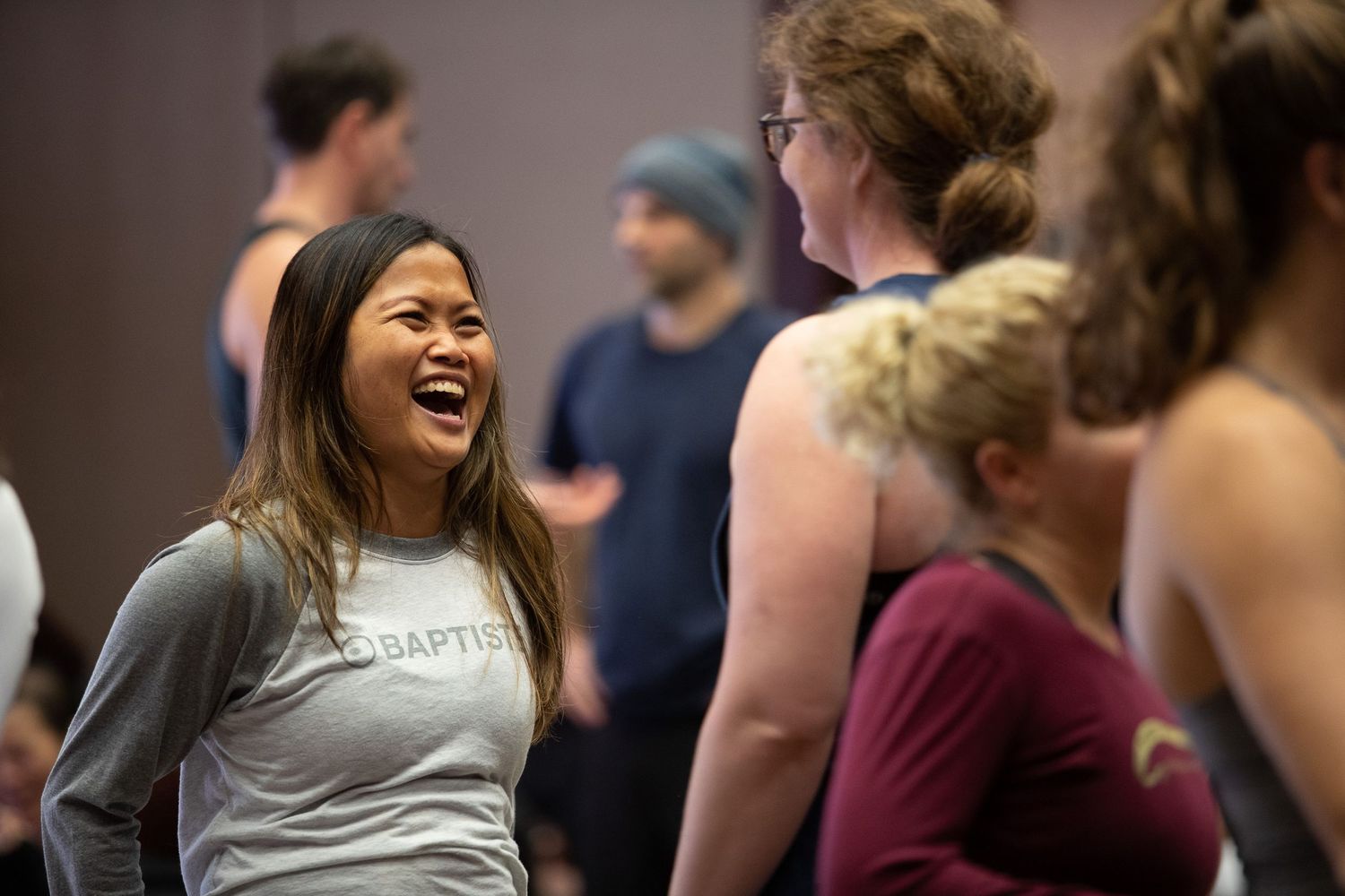 Participant sharing joyful moment during interactive fitness workshop session.