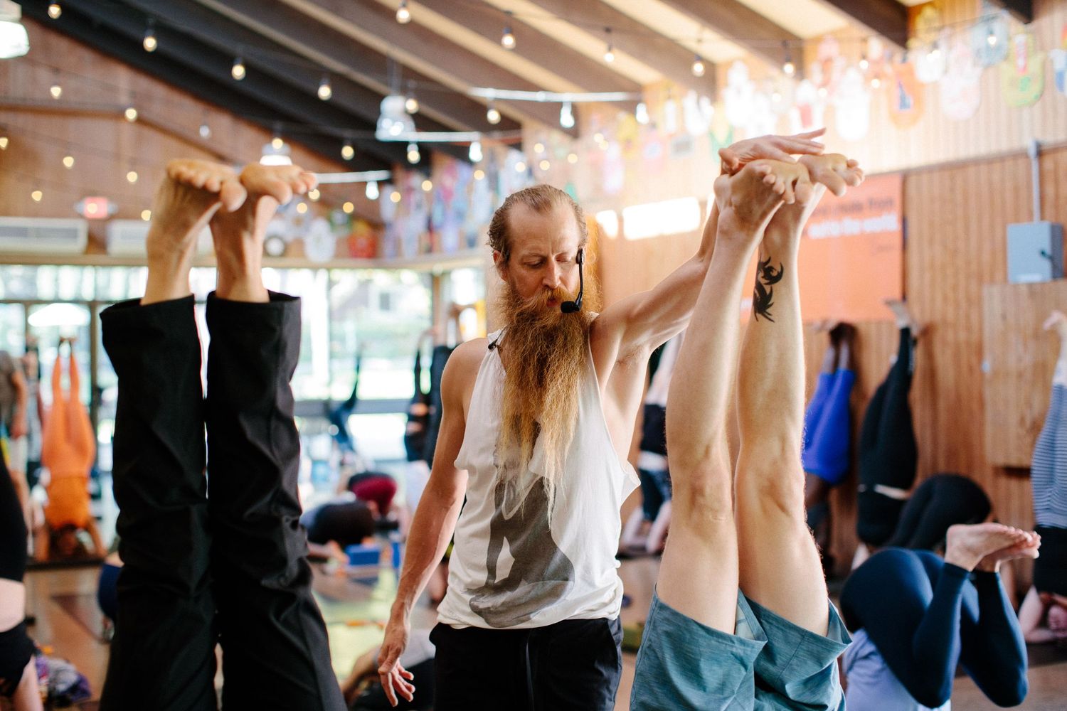 Group exercise participants stretch and move in synchronization during a fitness class.