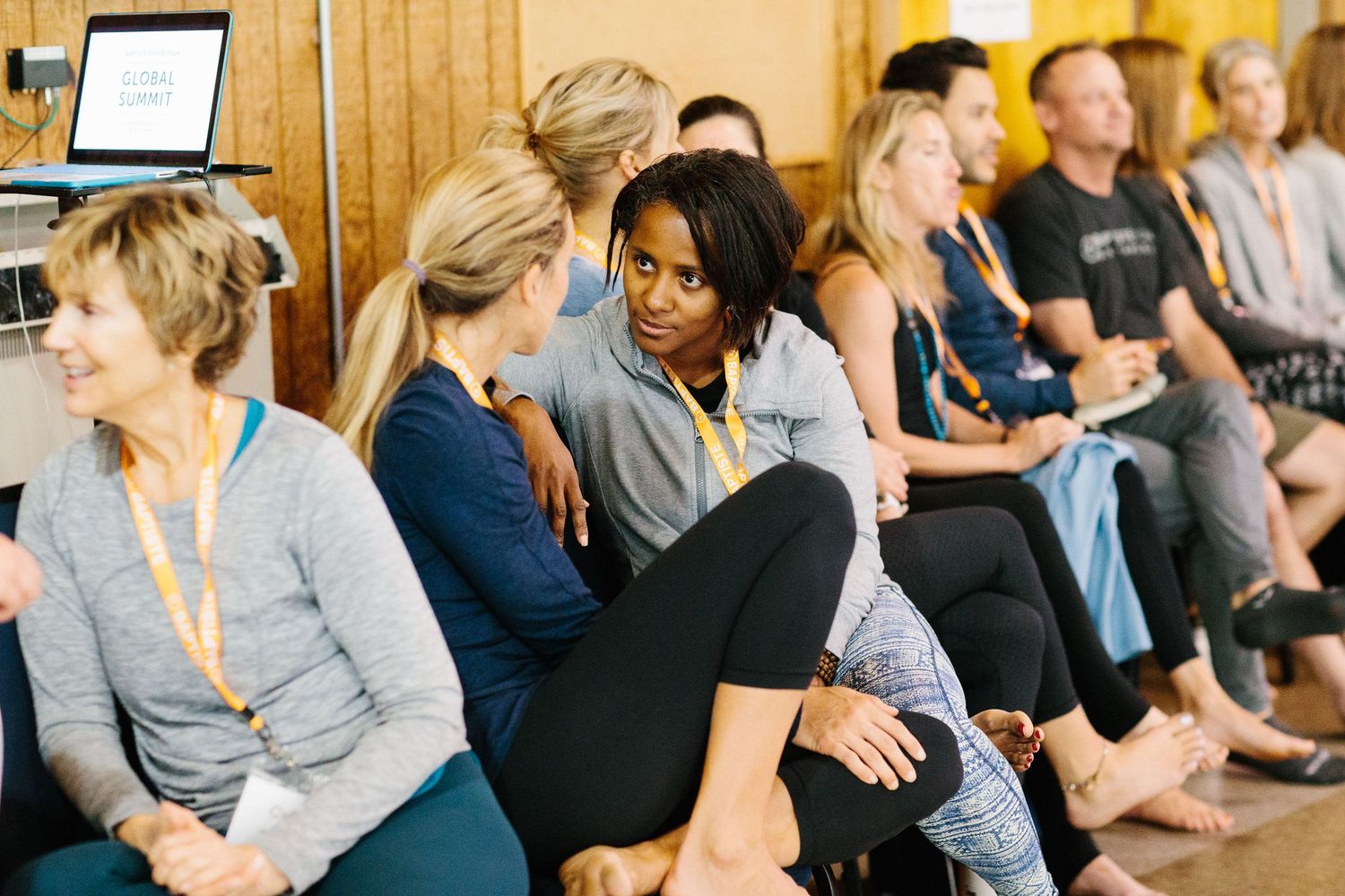 A diverse group of people sitting and chatting during a wellness event.