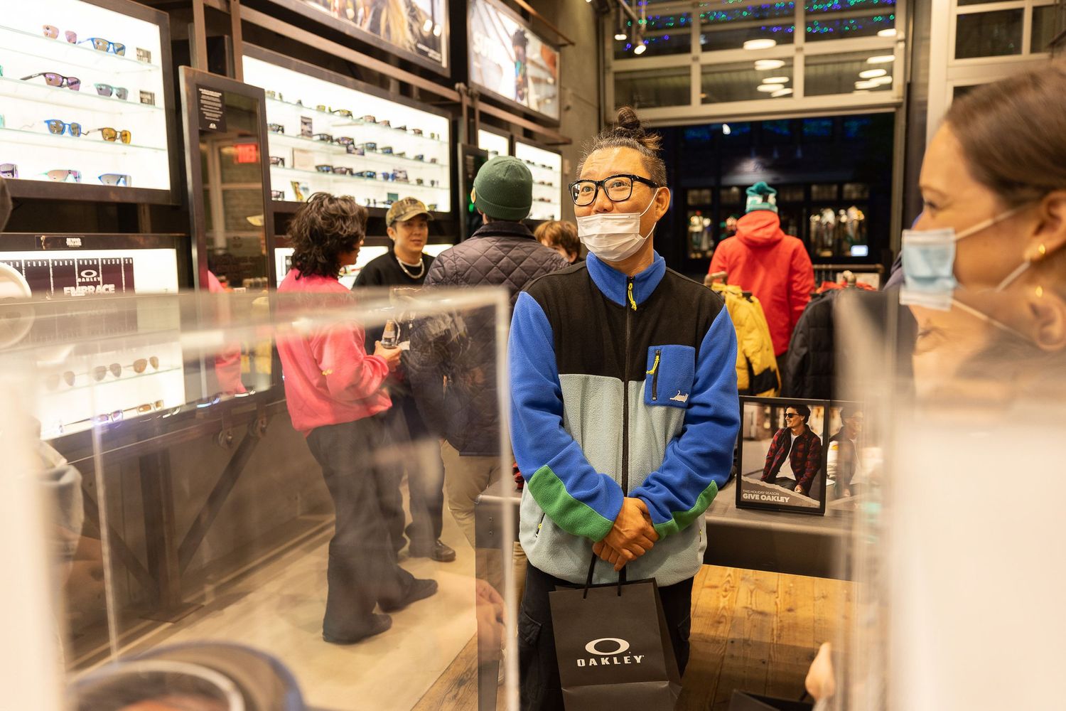 Customer browses eyewear selection at Oakley retail store.
