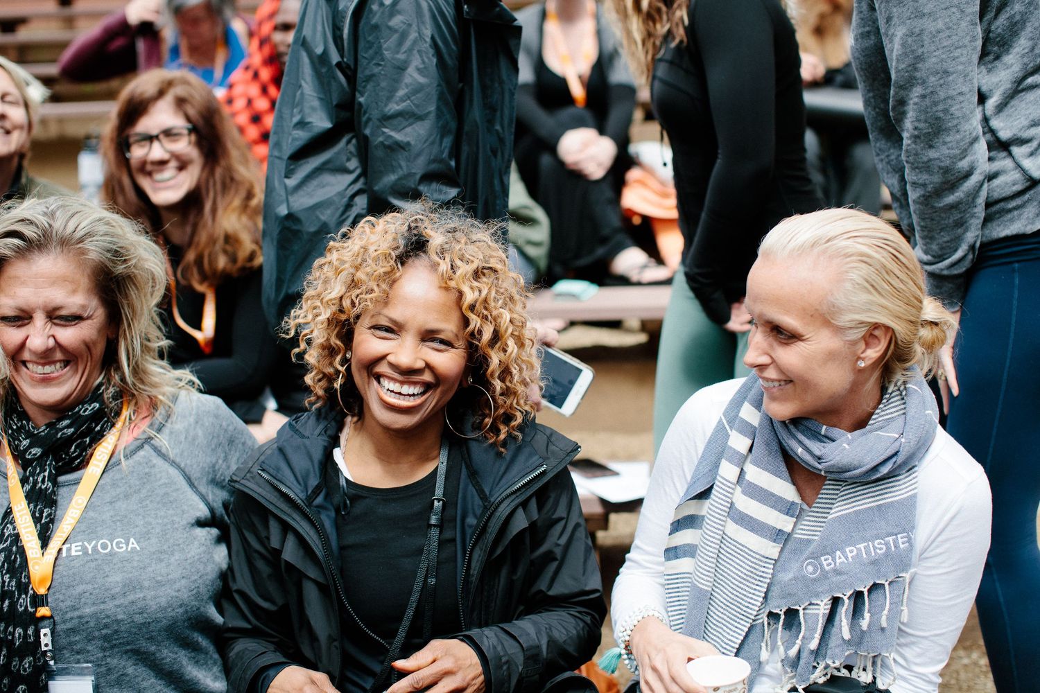 Participants sharing laughter and conversation during an indoor community gathering.