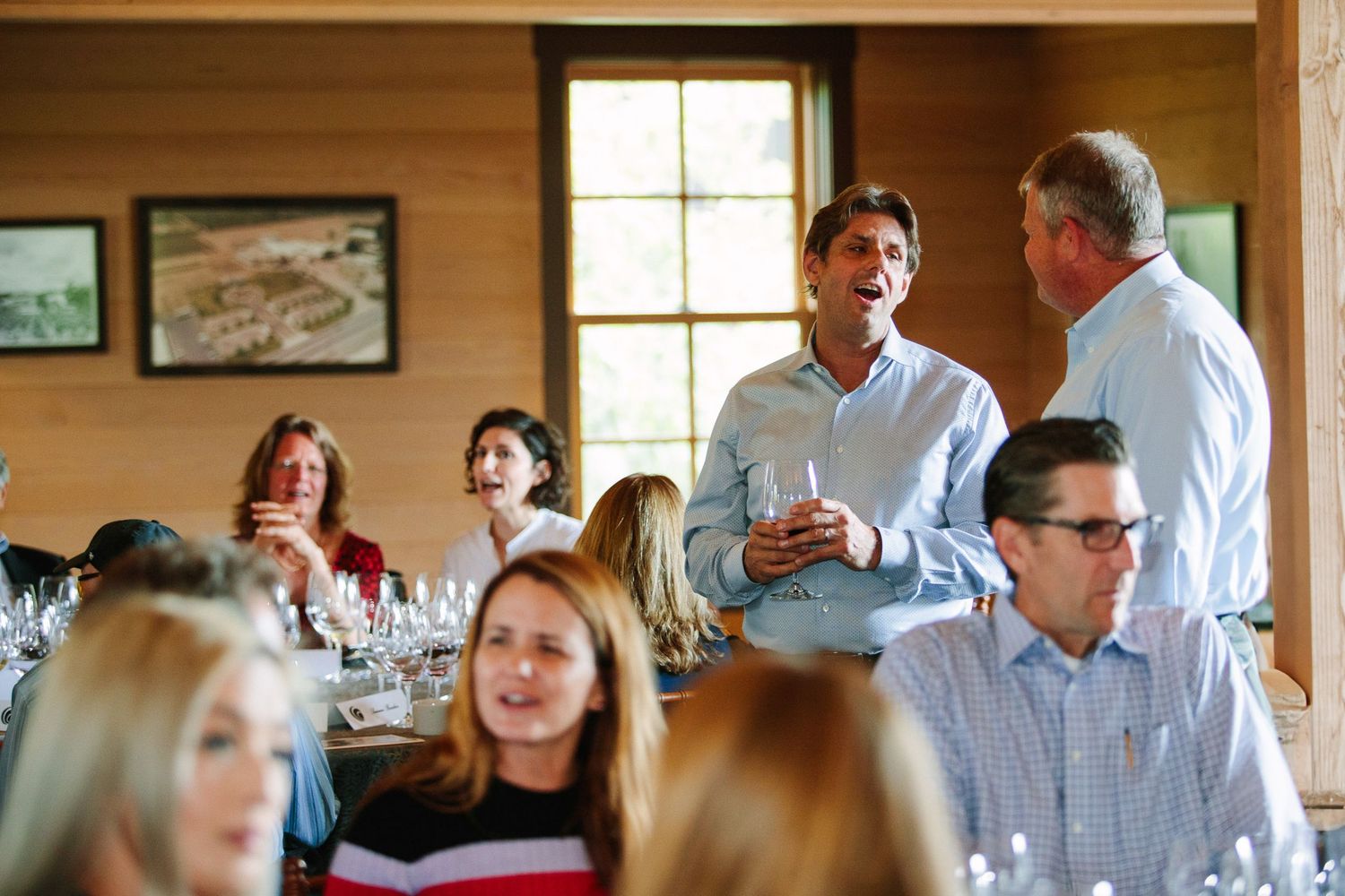 People gathered at tables during what appears to be a formal dining event or celebration.