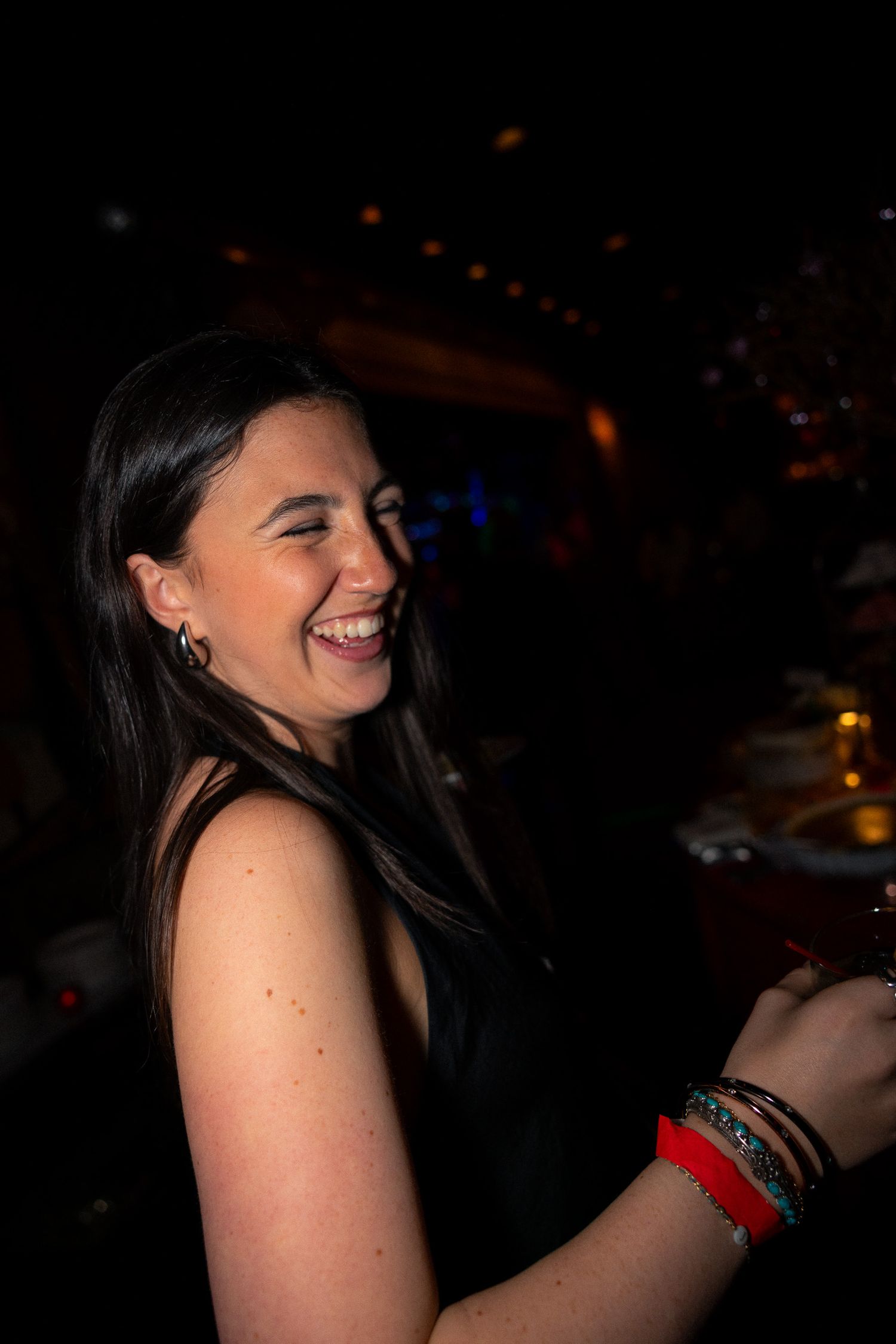 Guest enjoying themselves at a dimly lit evening celebration.