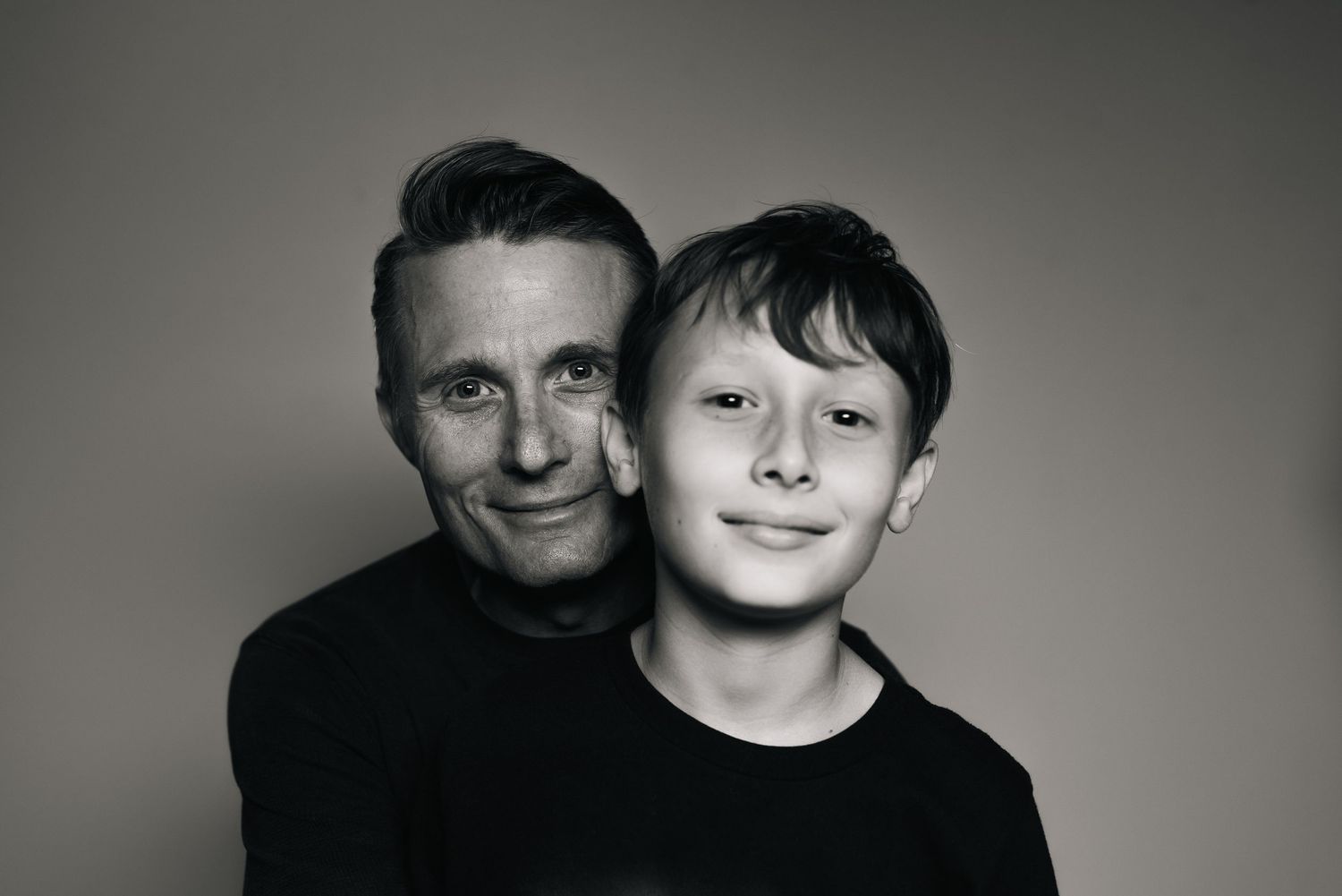 Black and white studio portraits showing intimate family moments.
