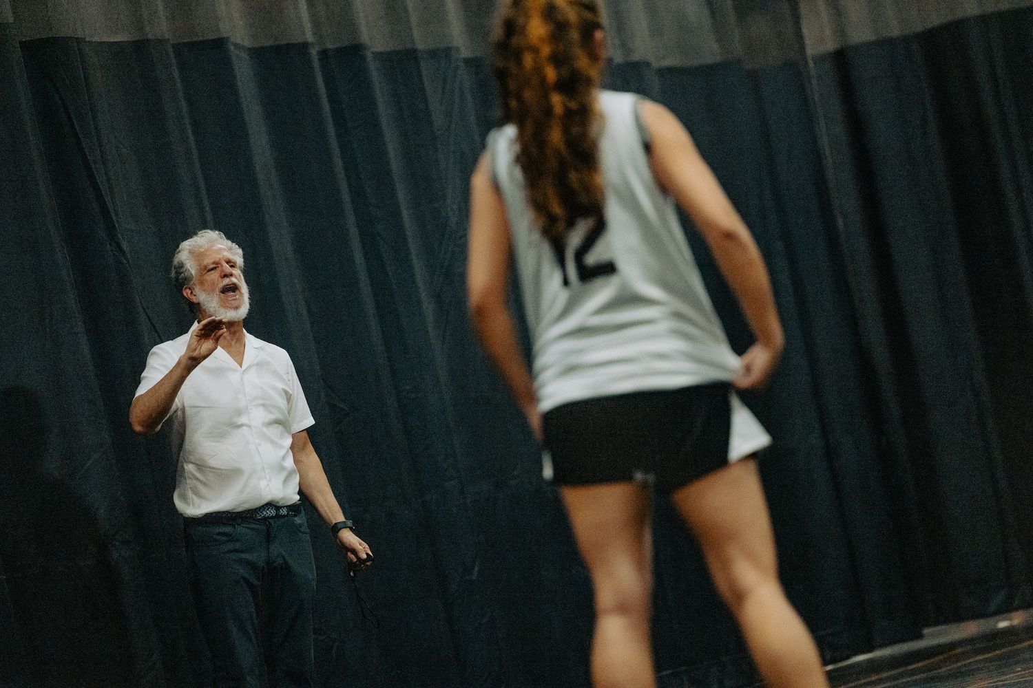 Coach provides instruction during basketball practice session.