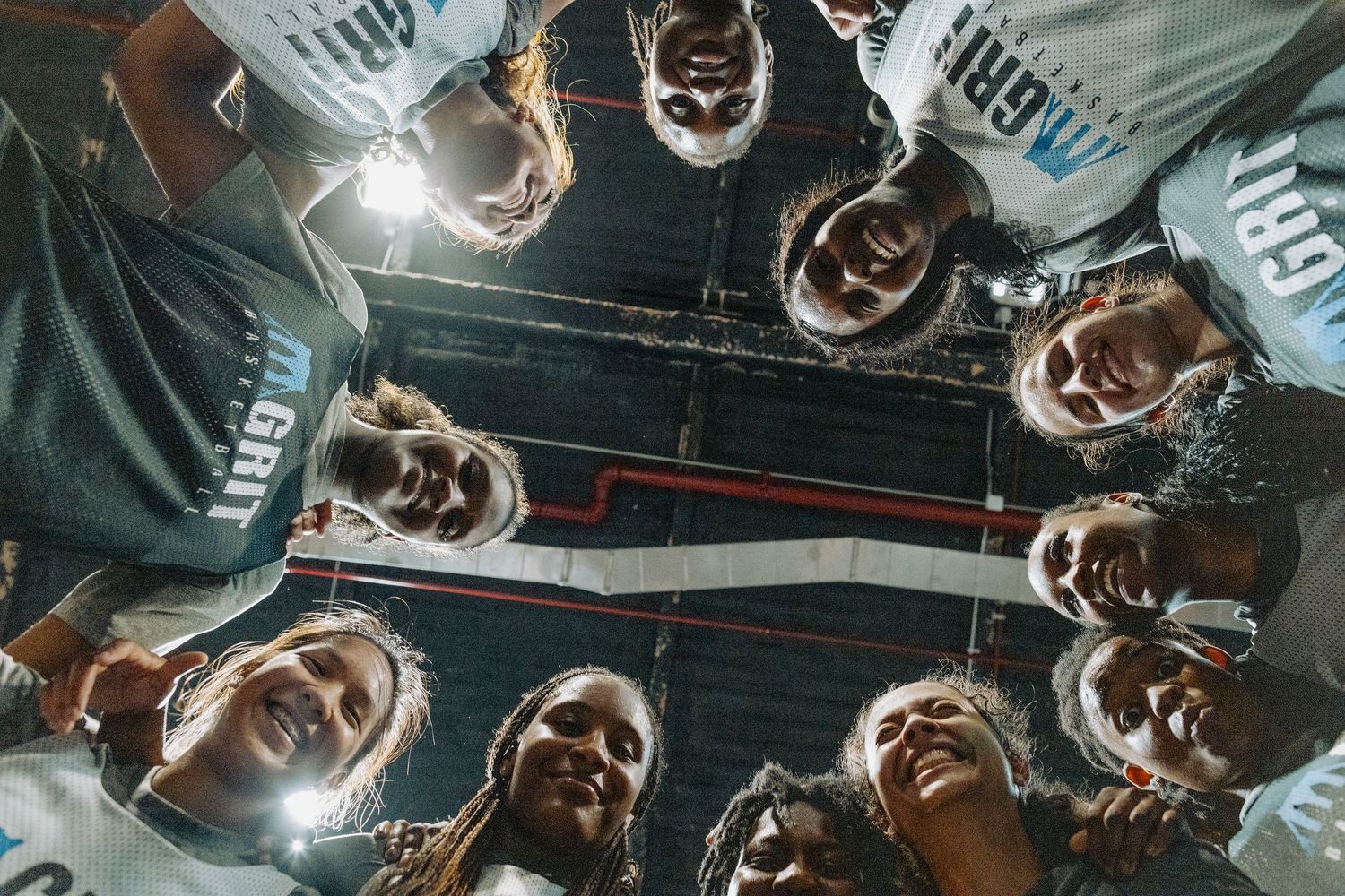Athletes in matching uniforms gathered in a circle during practice.