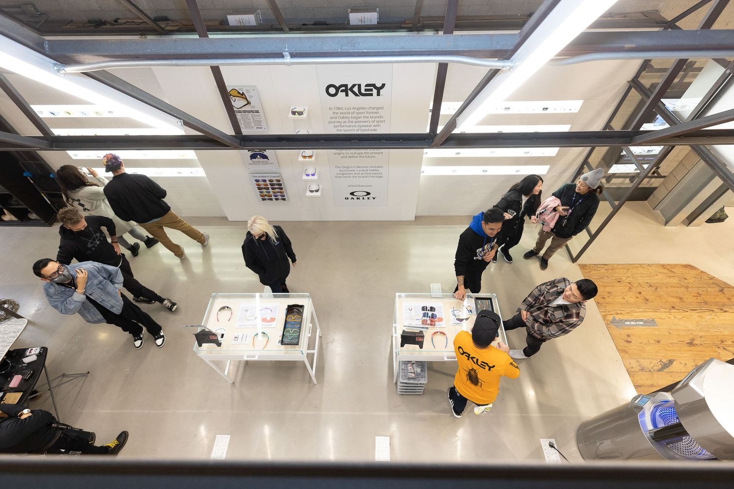 Wide angle view of people lined up in a bright industrial or retail space.