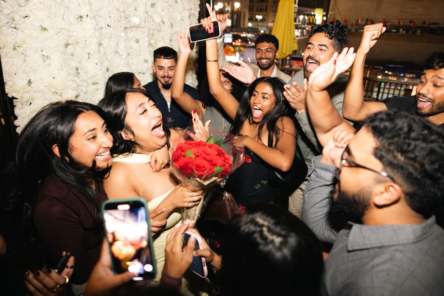 Crowd of people dancing and celebrating at a lively nightclub party.