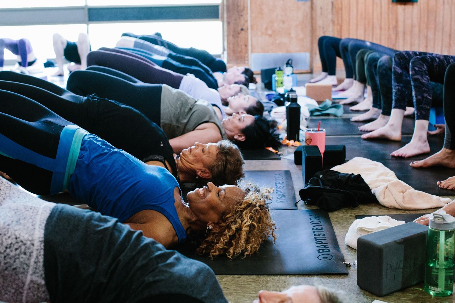 People lying on exercise mats during a relaxation or meditation session.
