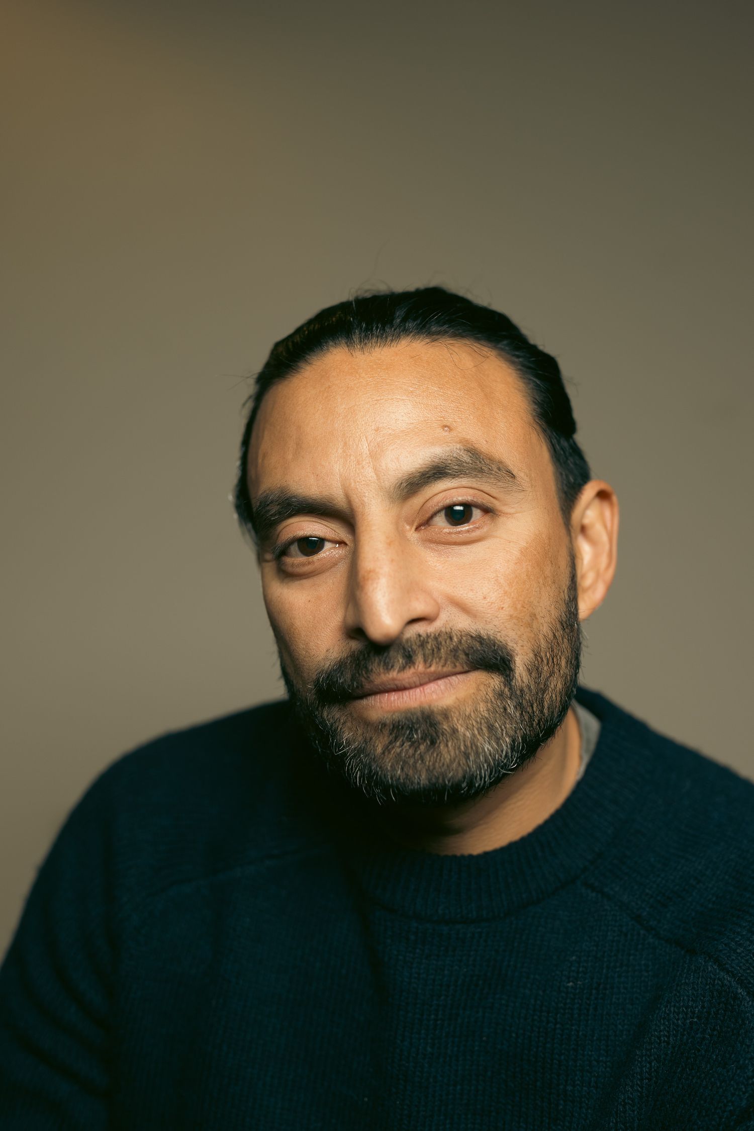 Studio portrait sequence showing expressions in dark lighting against neutral background.