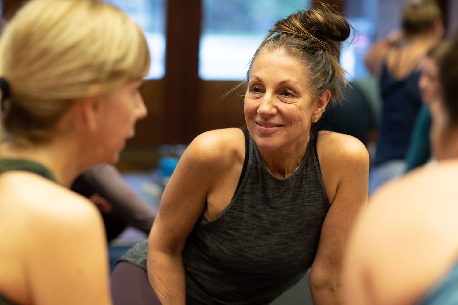 Energetic participants smiling and engaging in a fitness workshop.