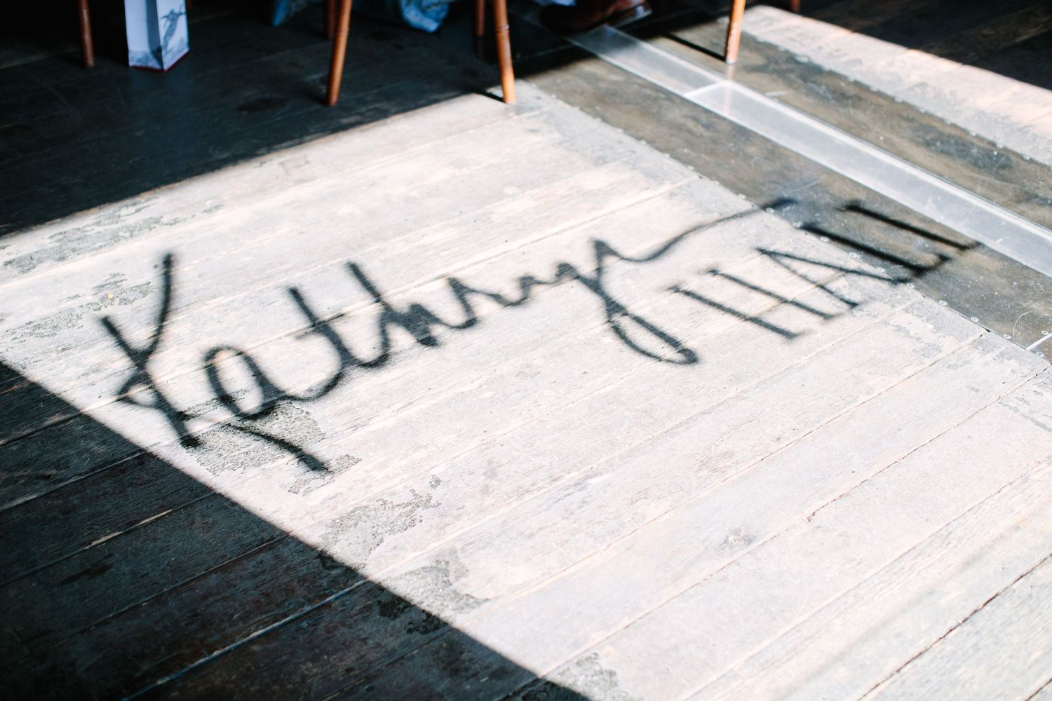 A handwritten signature or text written on a white surface.