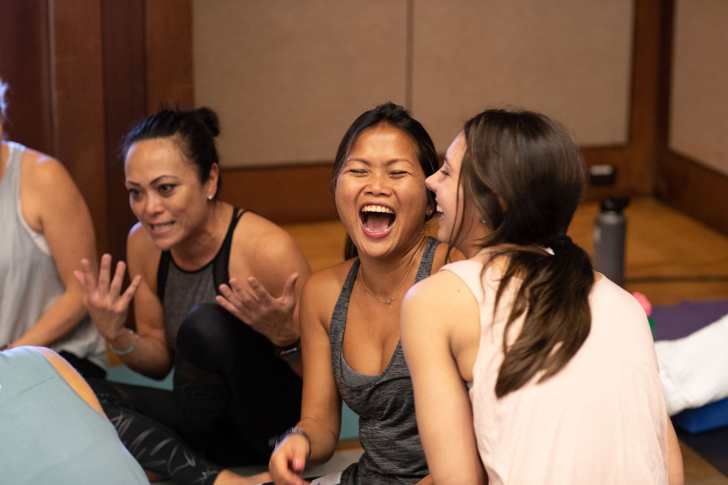 Participants sharing joyful moment during fitness workshop.