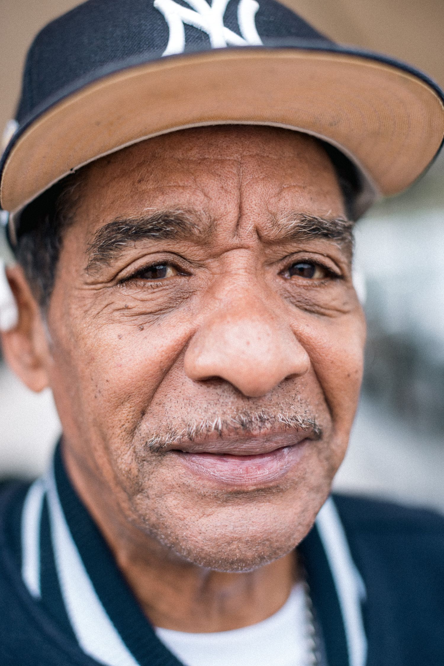A person in a Yankees baseball cap smiling at the camera.