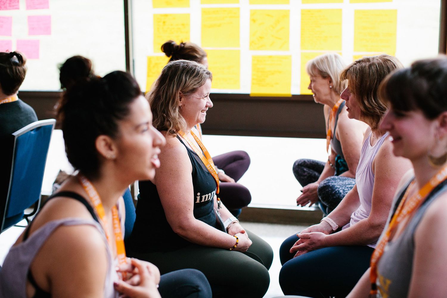 Group fitness participants engage in discussion during wellness workshop.
