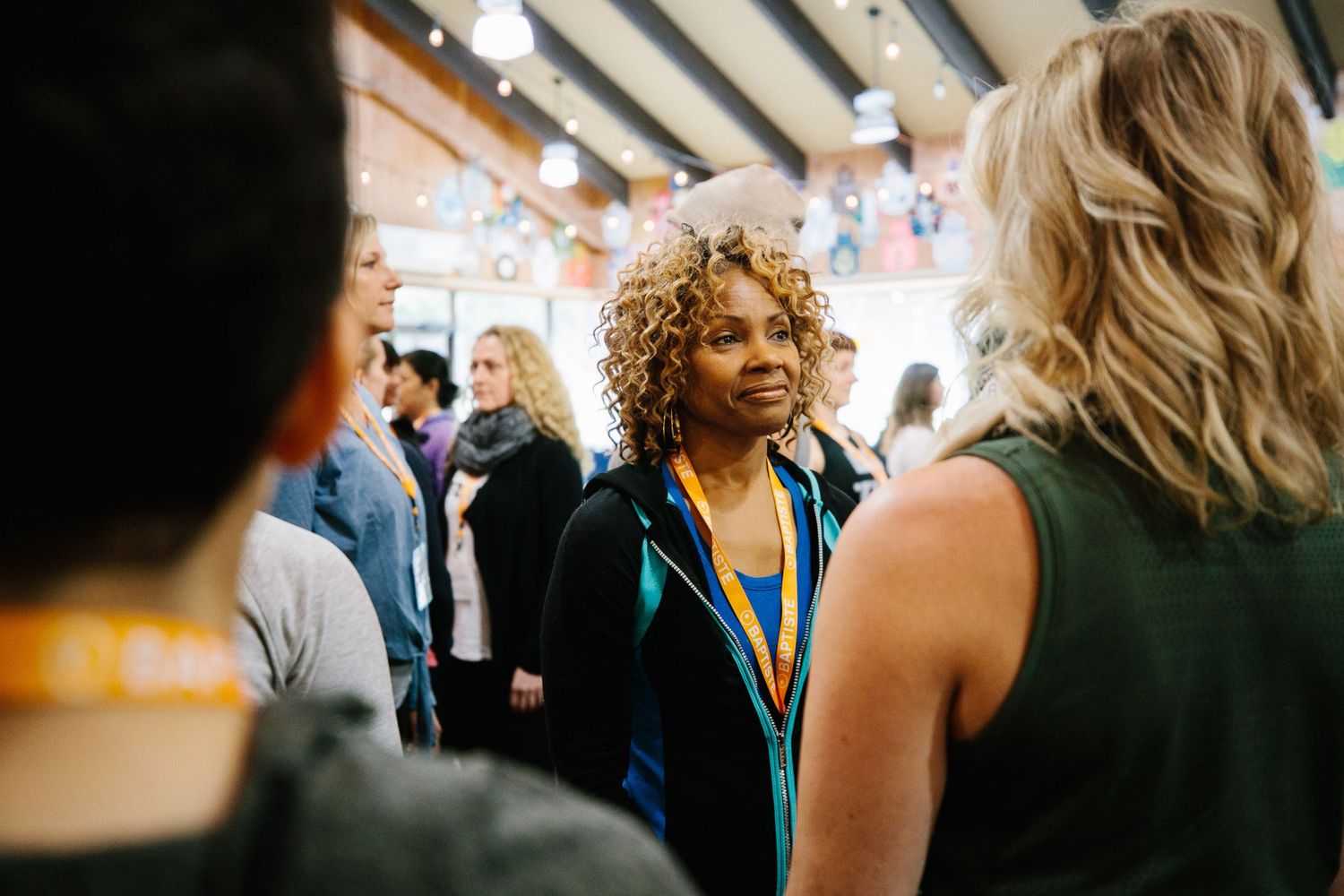 Attendees networking and mingling during an indoor professional event.