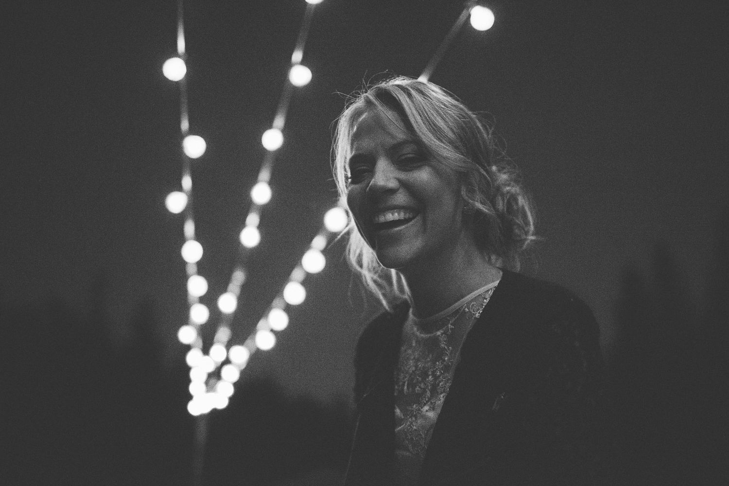 String lights create a warm bokeh effect against a dark background.