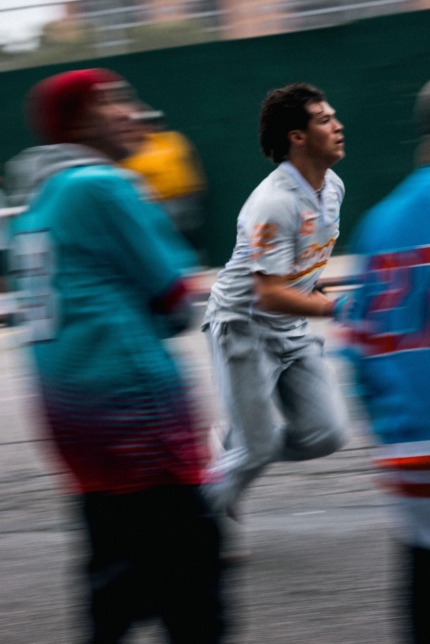 Athletes in motion during a street game with blurred action effect.