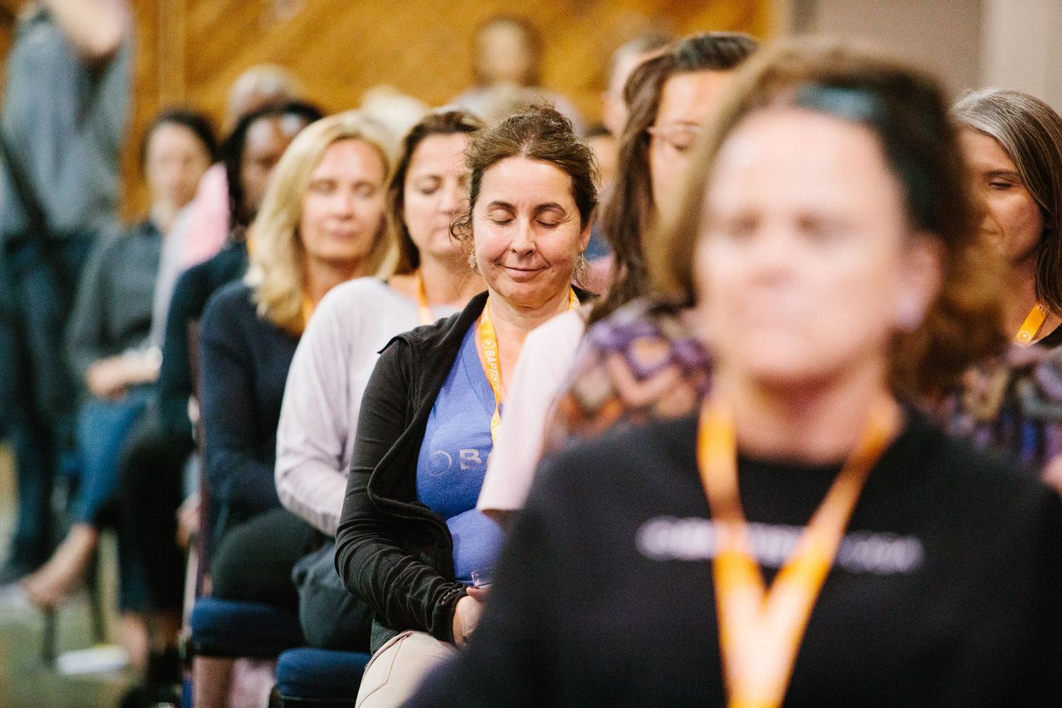 Attendees gathered in a warm-lit studio space for a community wellness event.