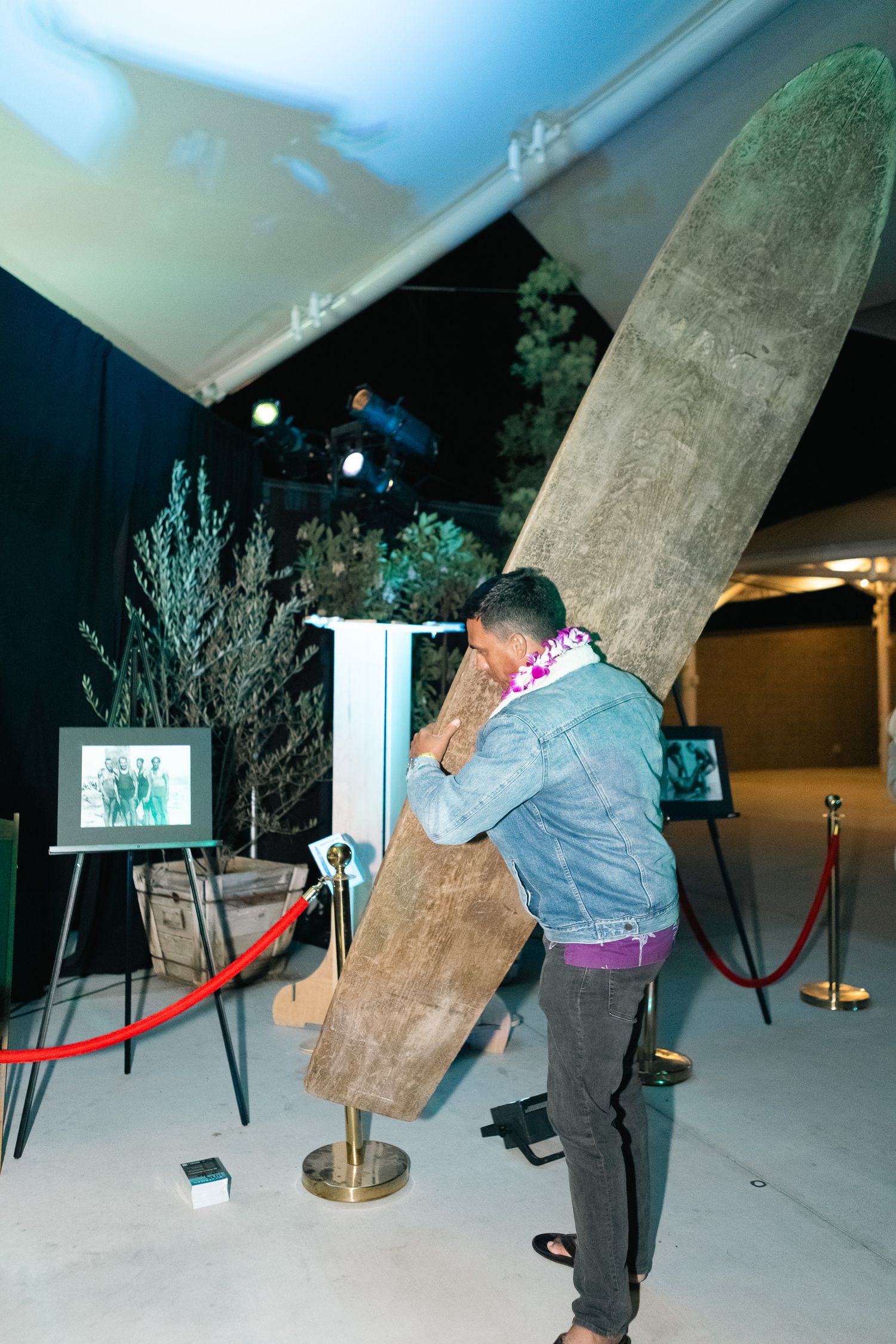 Person interacting with a large display or installation piece in an exhibition space.