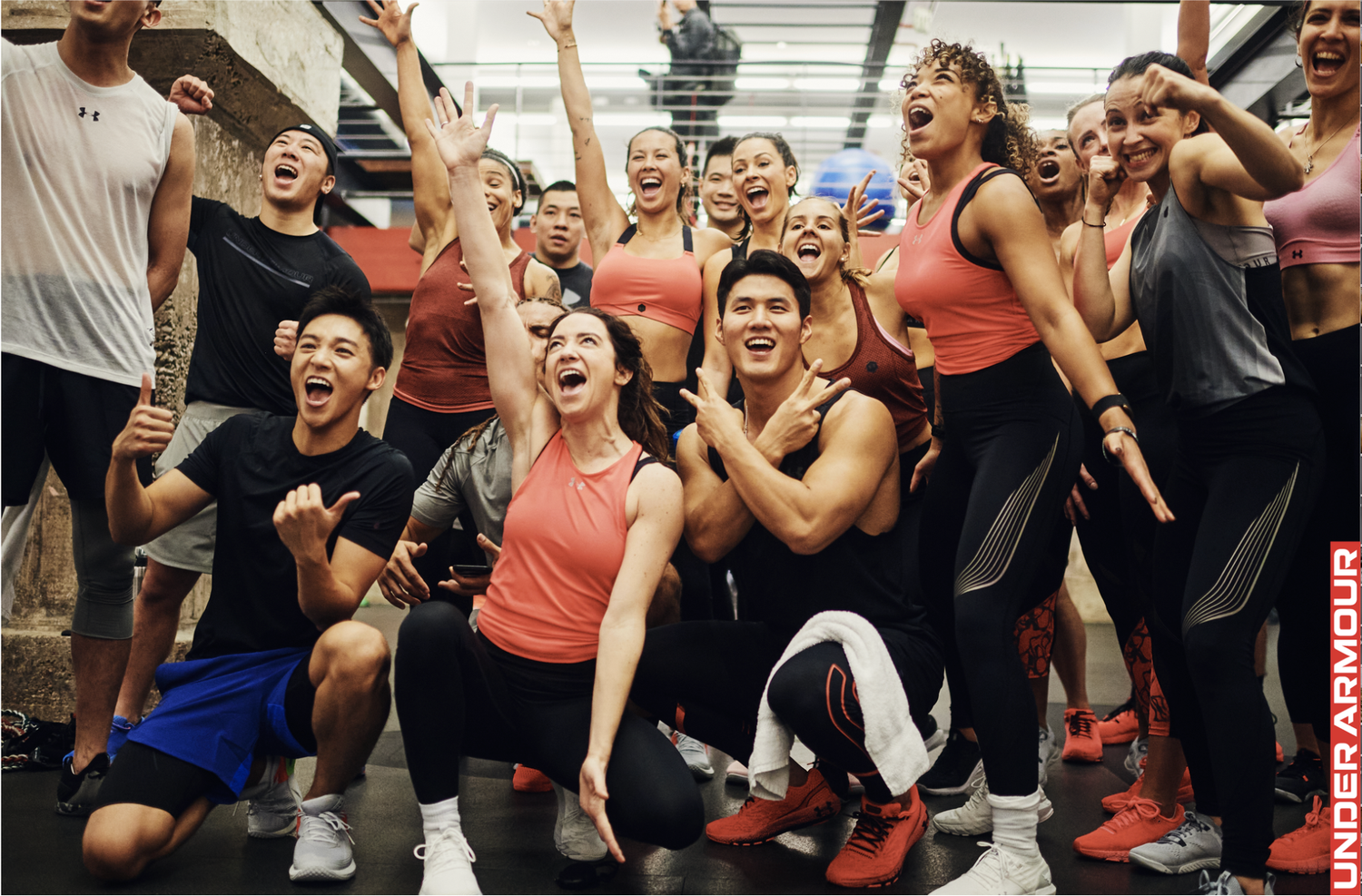 Group of people celebrate and cheer together in a lively indoor setting with joyful reactions and expressions.