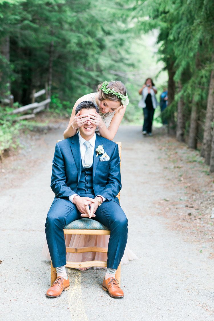 A playful moment captured on a wooden bench along a forest path.