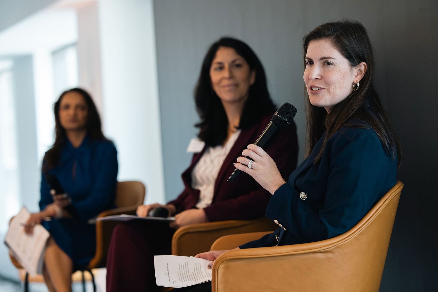 Business professionals engaged in discussion during a conference meeting in a bright modern office setting.