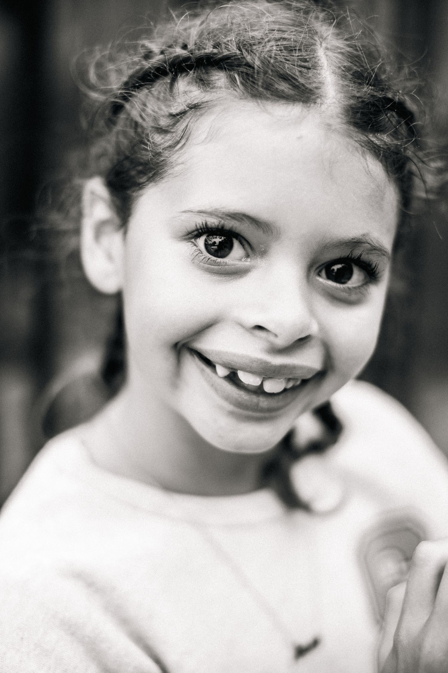 Black and white portrait series showing expressive smiles and joyful emotions.