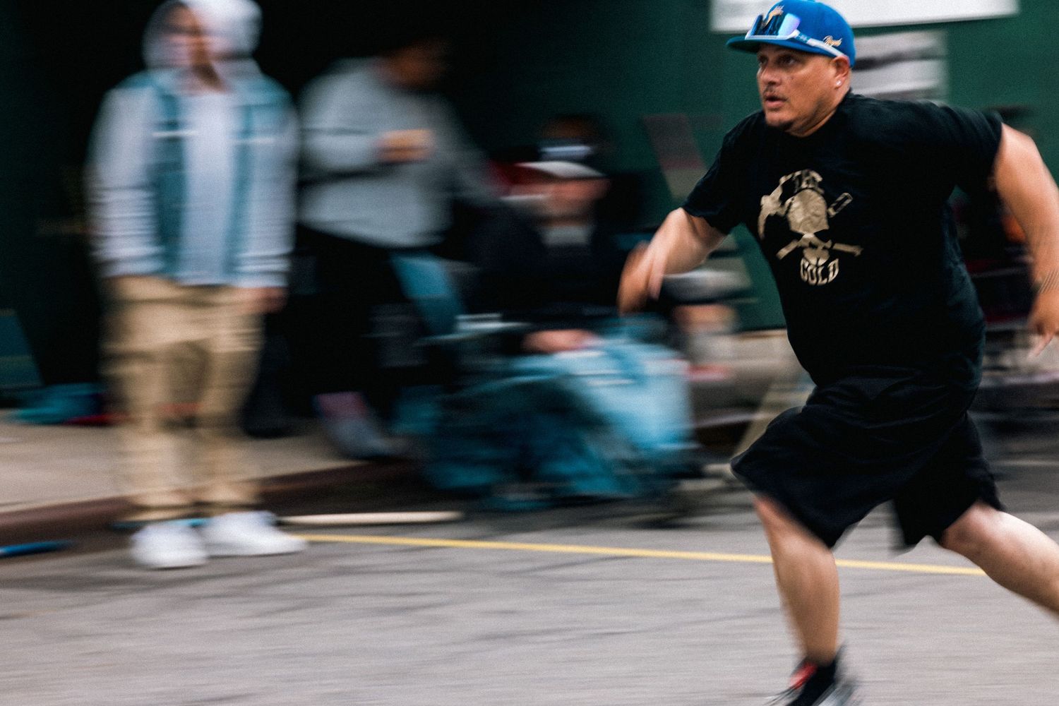 Motion-blurred action shot of someone running in dark clothing.