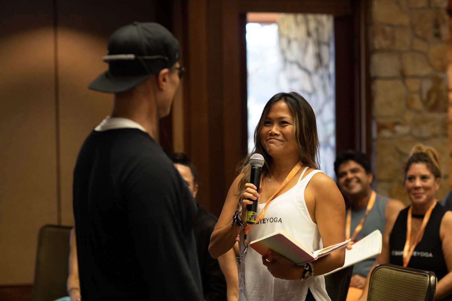 Workshop participants engage in discussion during an indoor conference session.