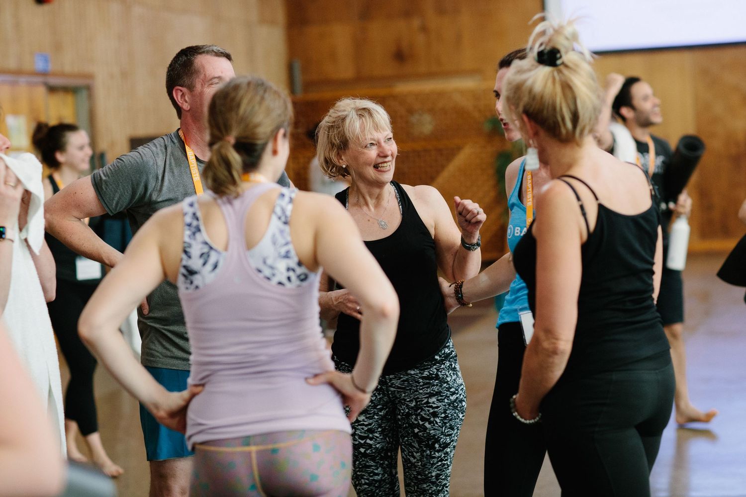 Group of fitness enthusiasts chatting during a workout class break.