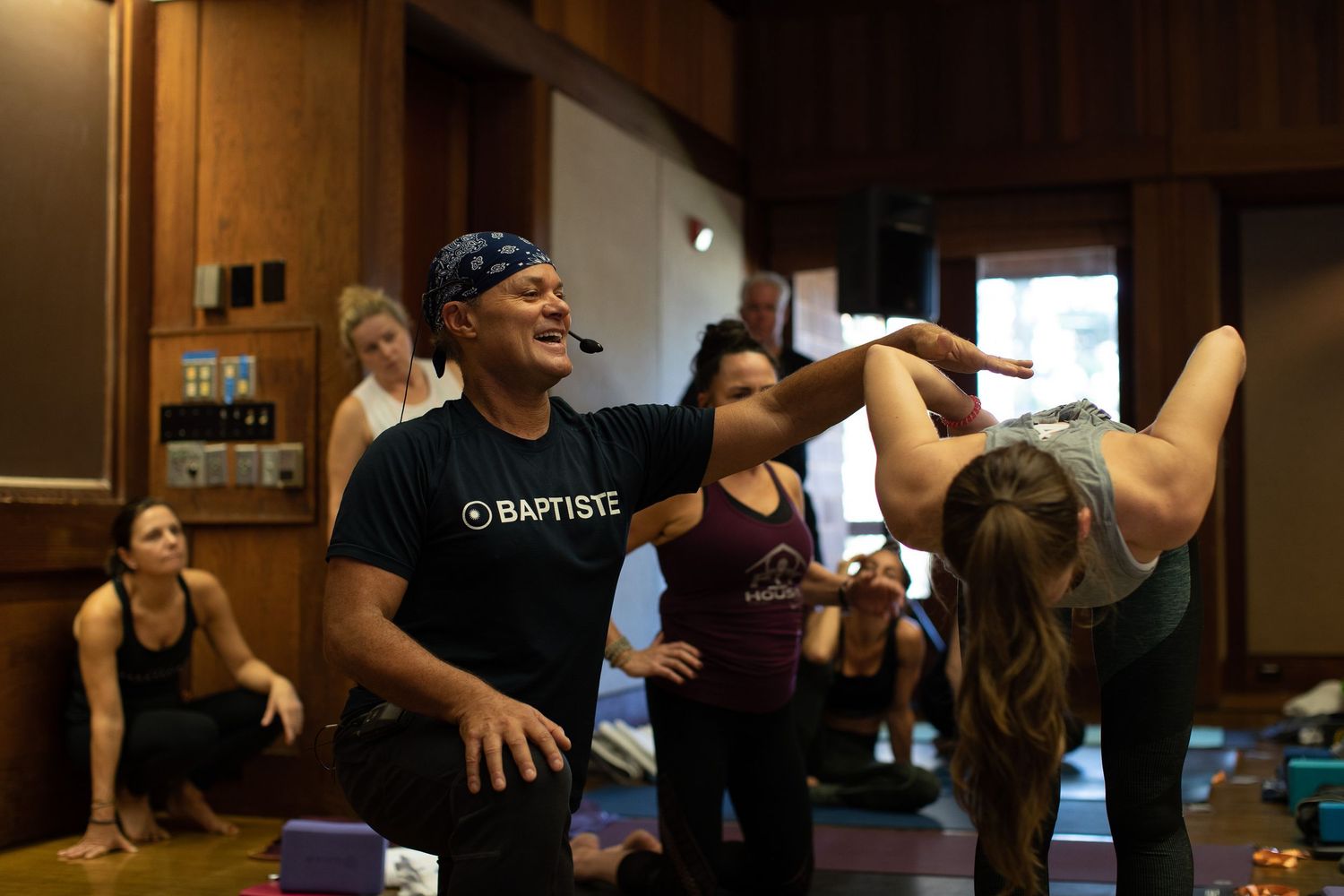 Participants engaged in dynamic movement during an indoor fitness class.