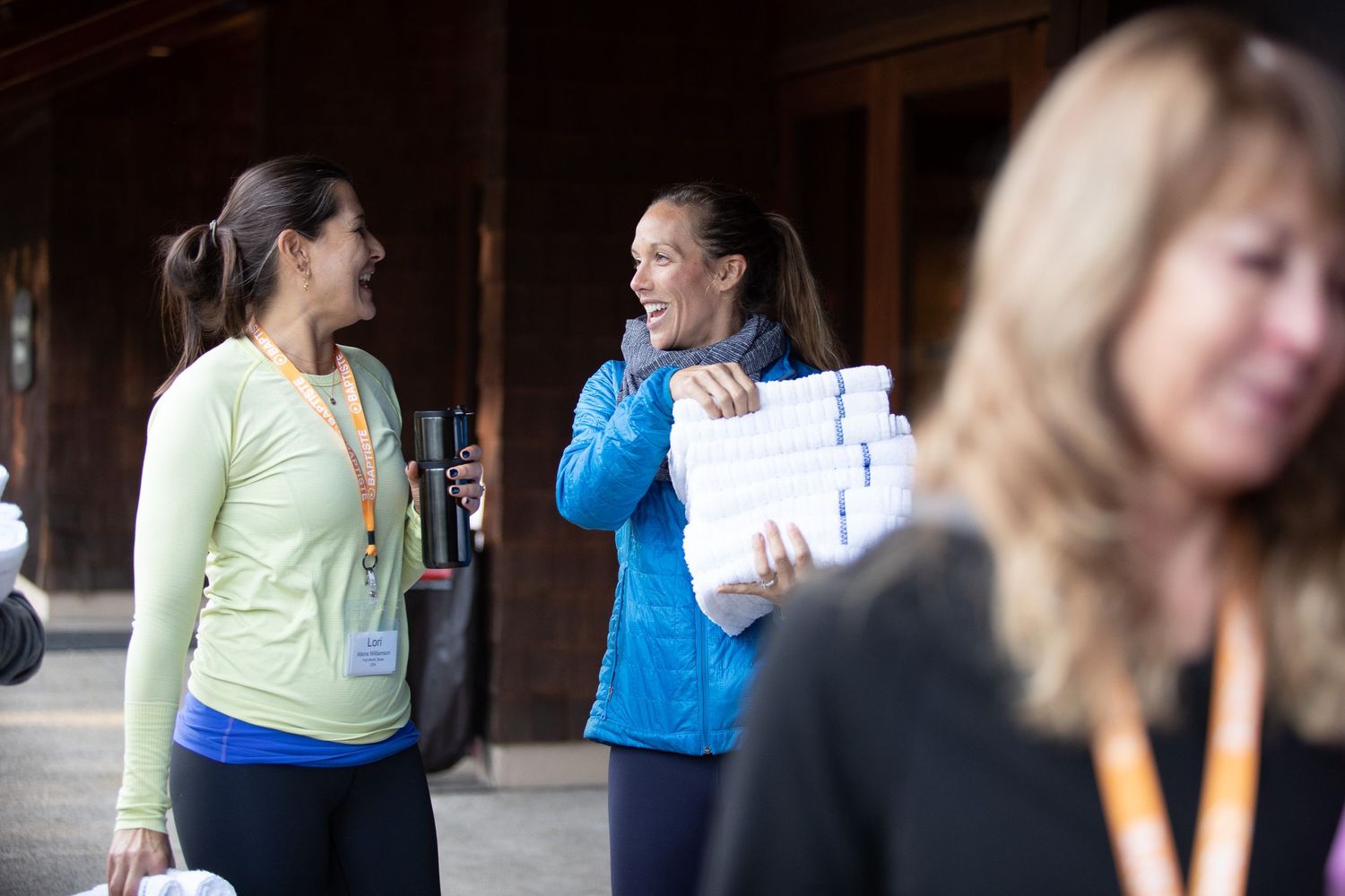 Participants in athletic wear having conversation outdoors.