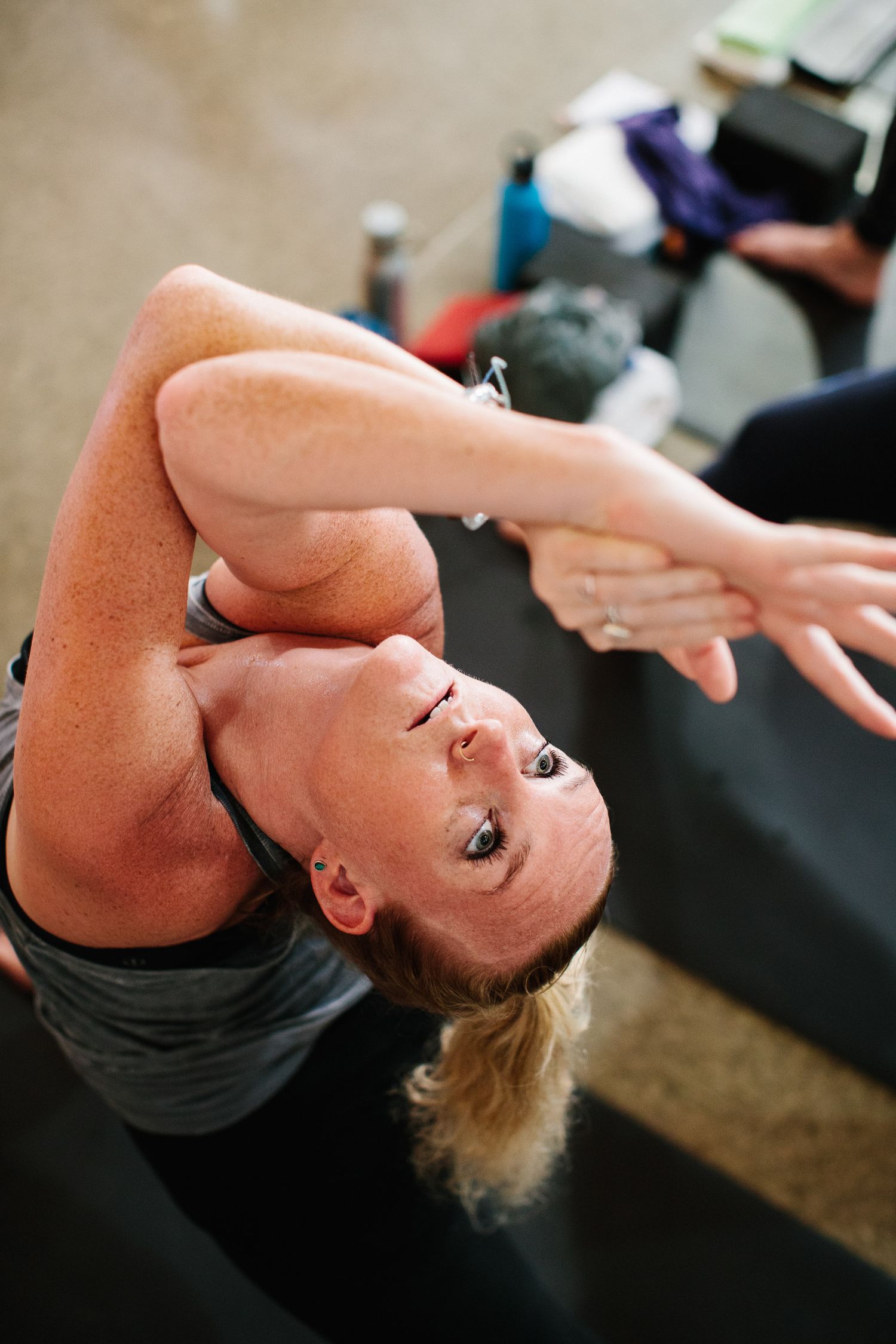 Several people practicing yoga backbends during a studio class.