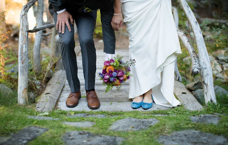 Creative shoe shots of wedding party members standing together outdoors.