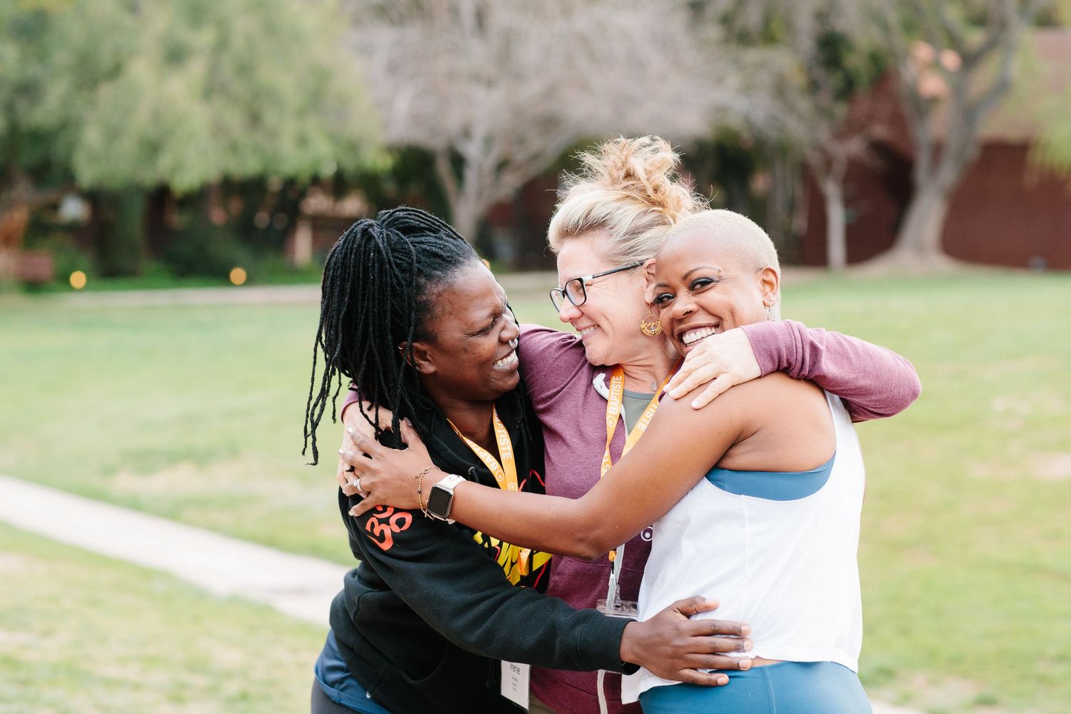 Partners embracing during outdoor dance practice session in sunny weather.