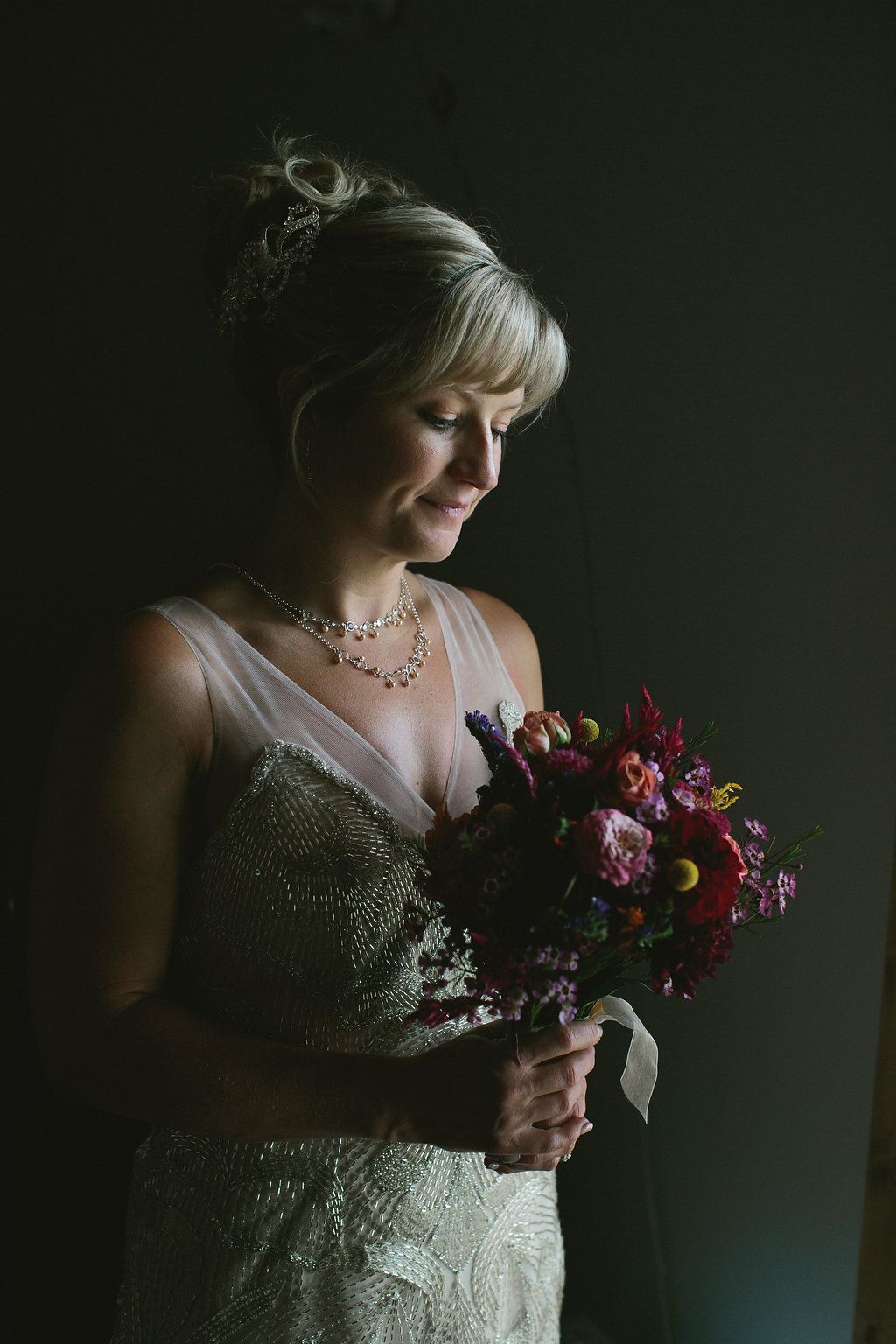 Photography of editoral style bridal portraits with a dramatic bouquet beautifully posed in indoor setting Brooklyn New York