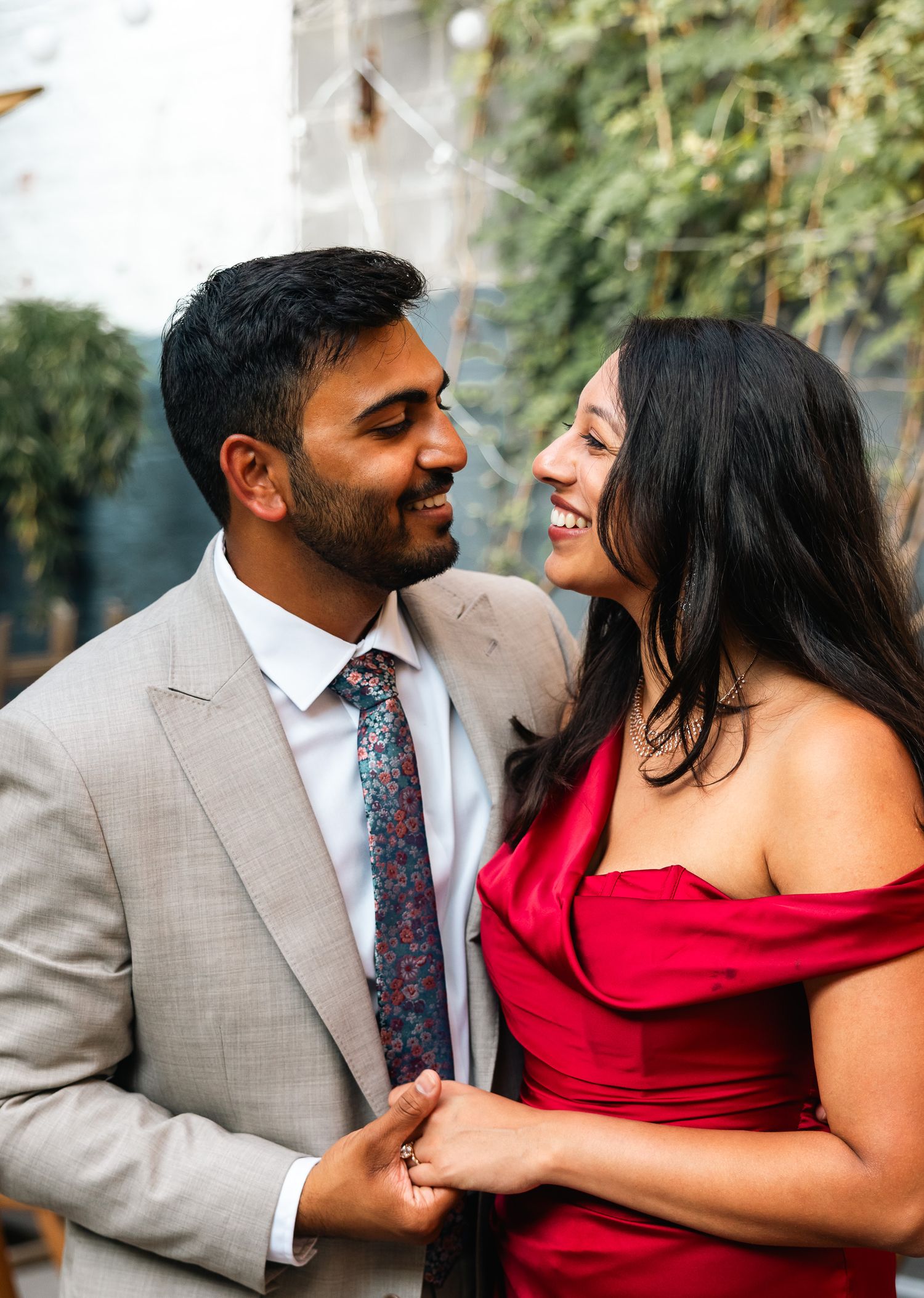 Couple in formal attire sharing intimate moment during outdoor photo session.
