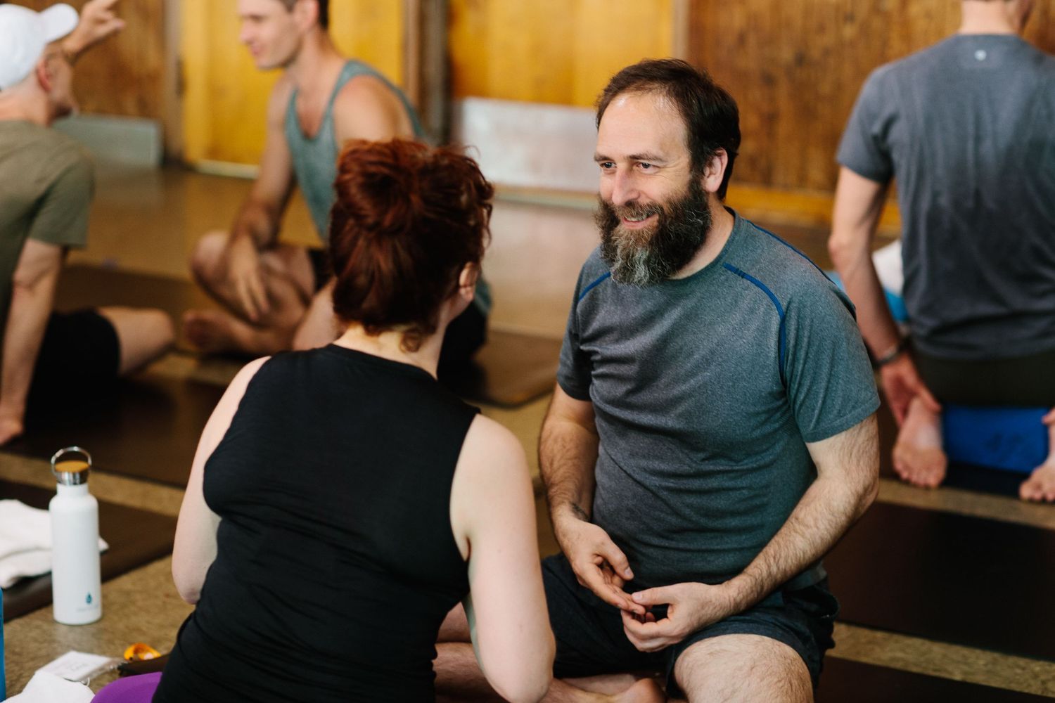 Participants engaged in conversation during a casual indoor workshop session.