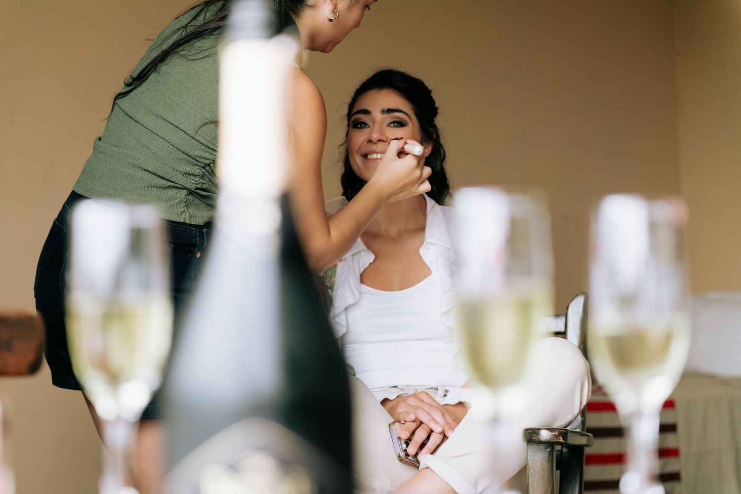 Elegant wedding celebration with champagne flutes and guests toasting at a reception party.