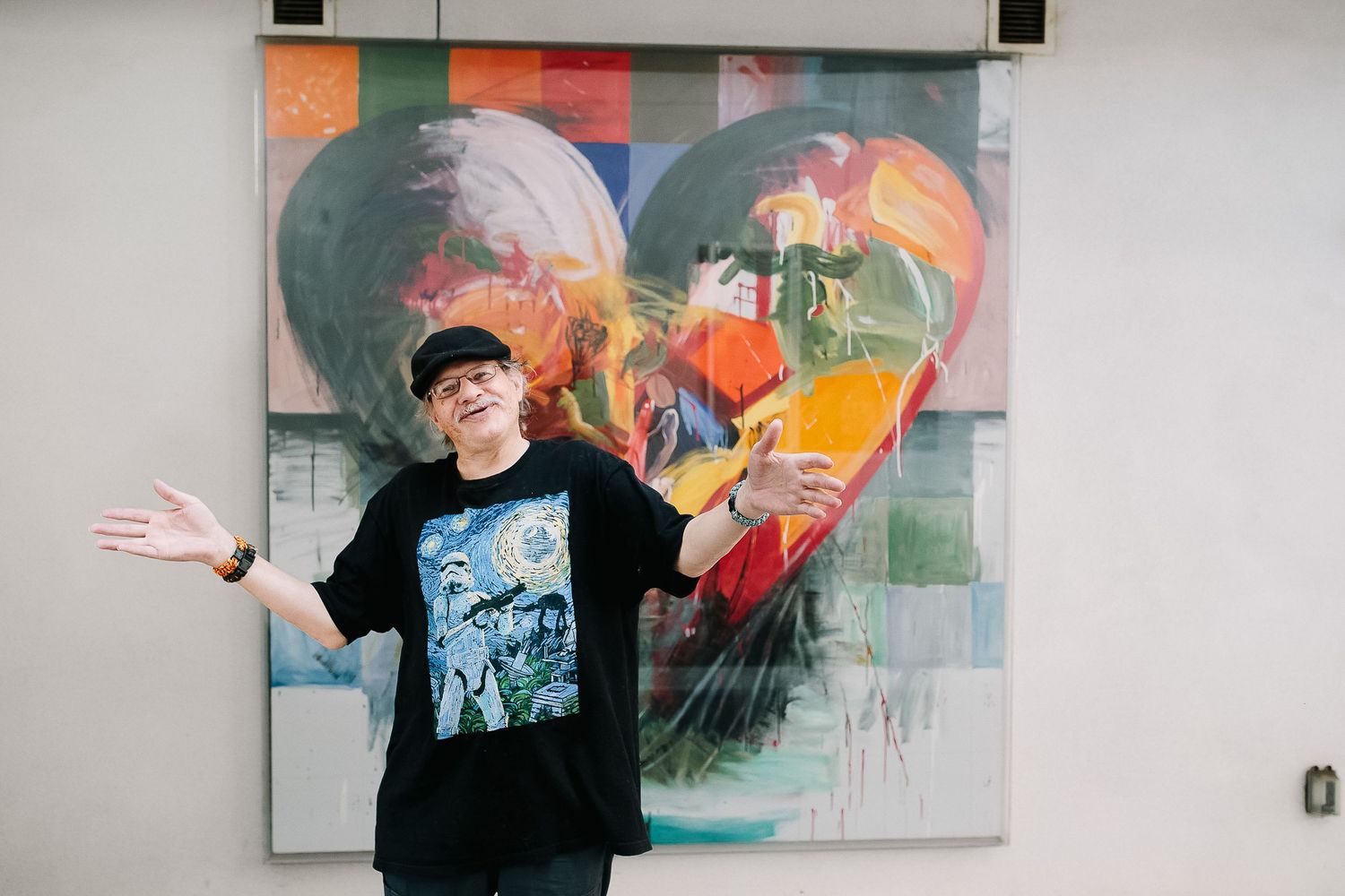 Abstract colorful graffiti art displayed as a gallery collage of multiple vibrant pieces on white walls.