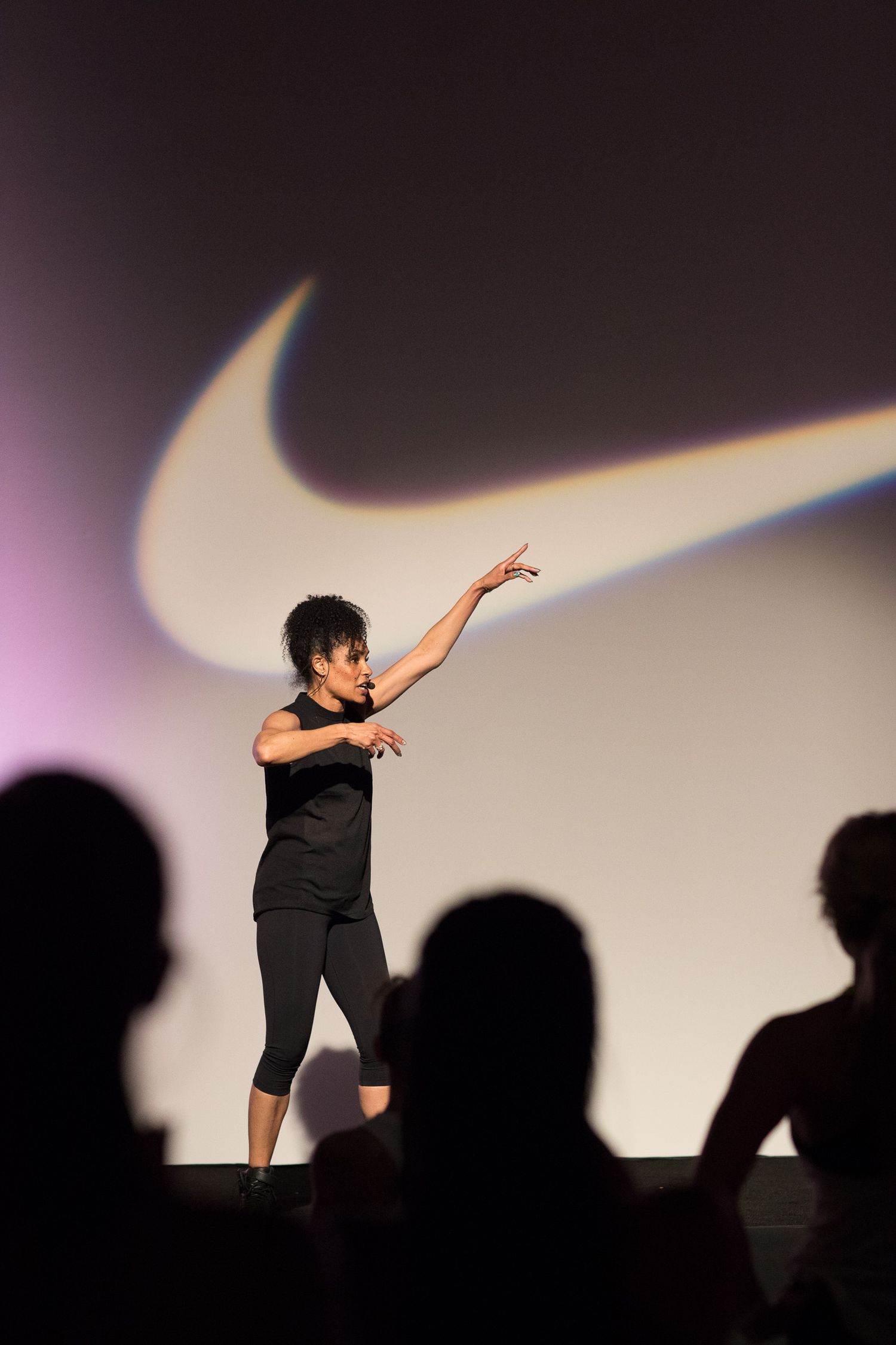 Silhouetted dancer performing dynamic movements against a light background.