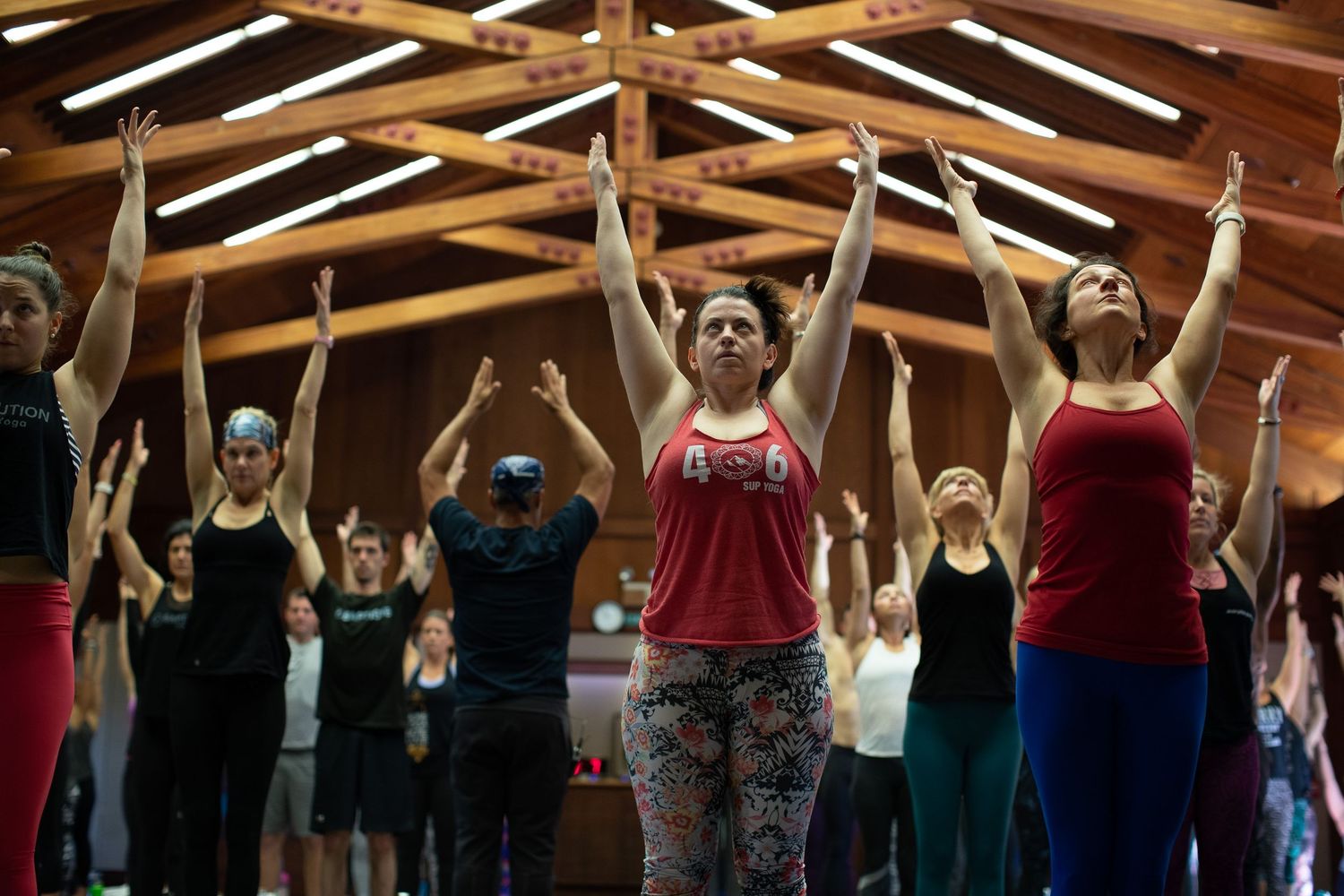 Synchronized group raising arms in a coordinated fitness movement.