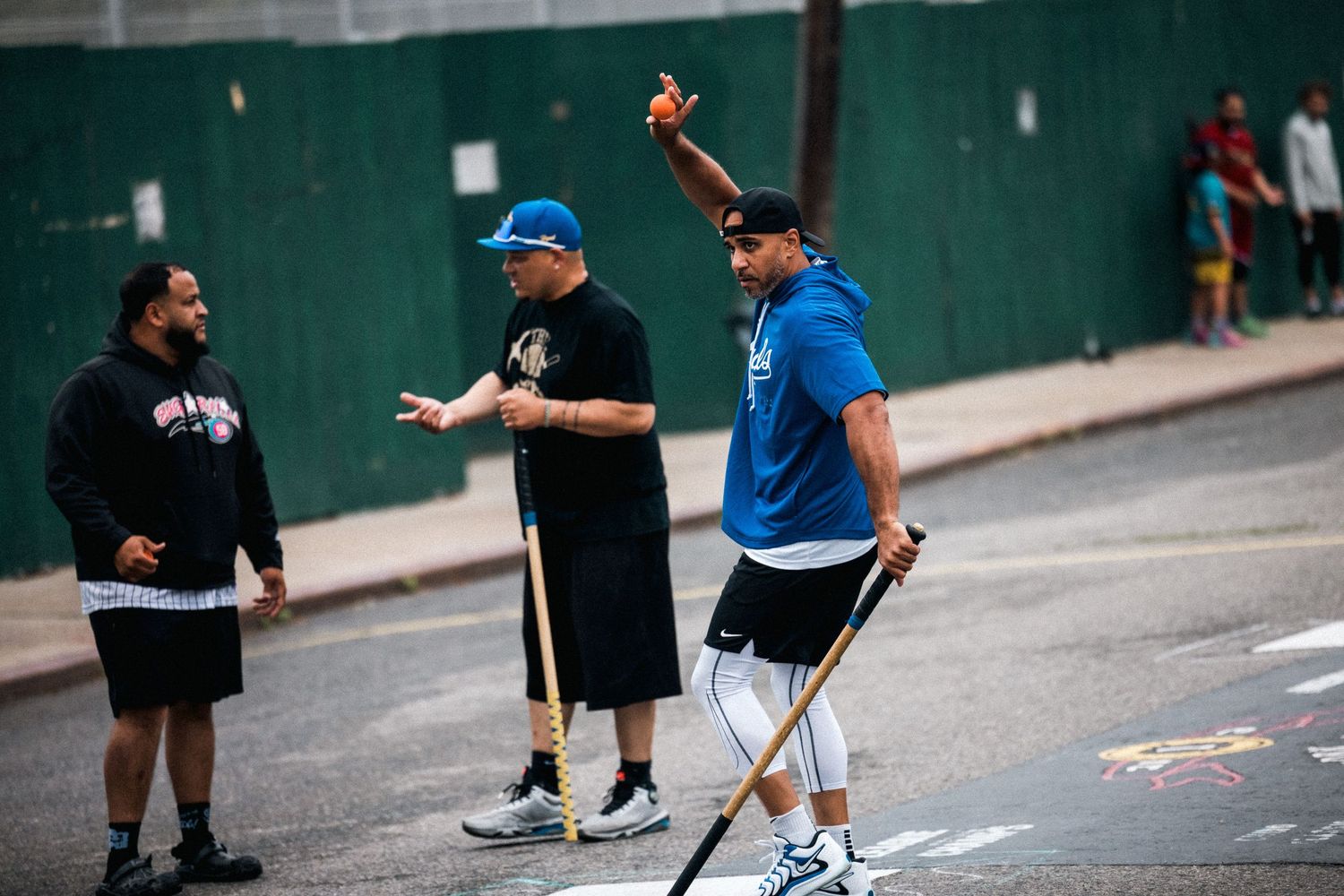 Group of people engaged in street dance activities against urban backdrop.