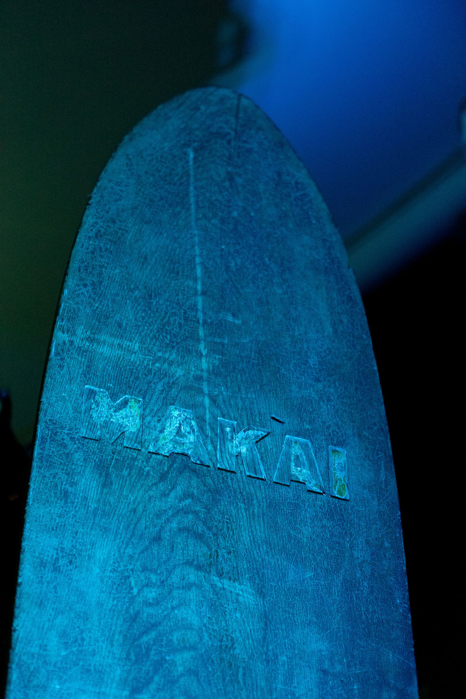 Close-up shot of a blue-lit textured surface with engraved or embossed lettering.